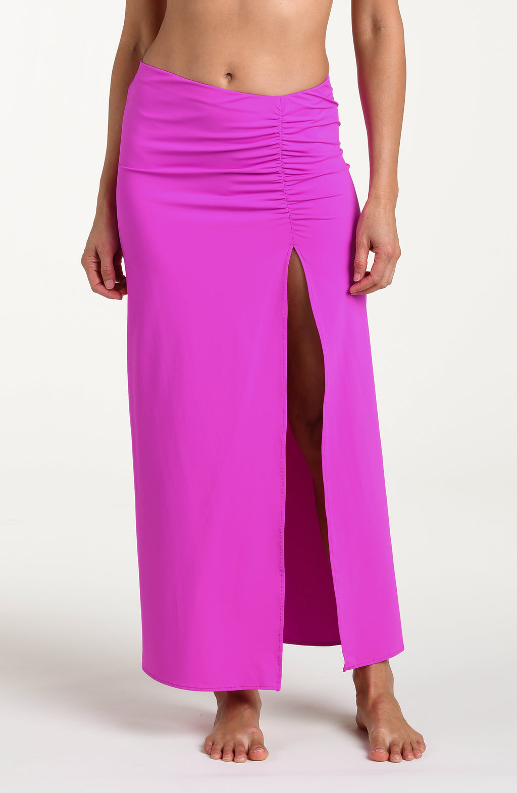 Woman wearing a violet colored maxi skirt against a white background. 