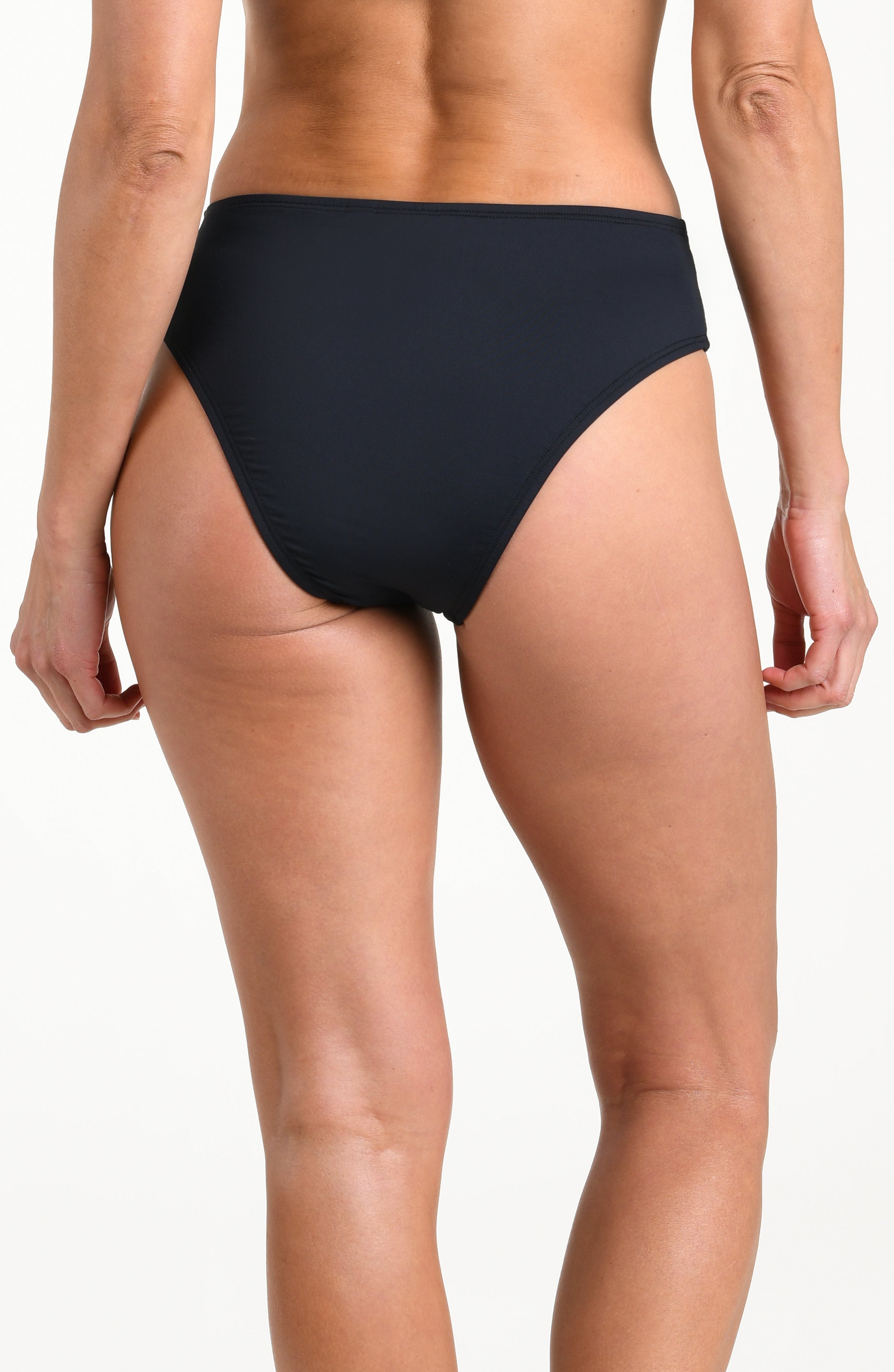 Person wearing black high-waisted bikini bottoms on a white background