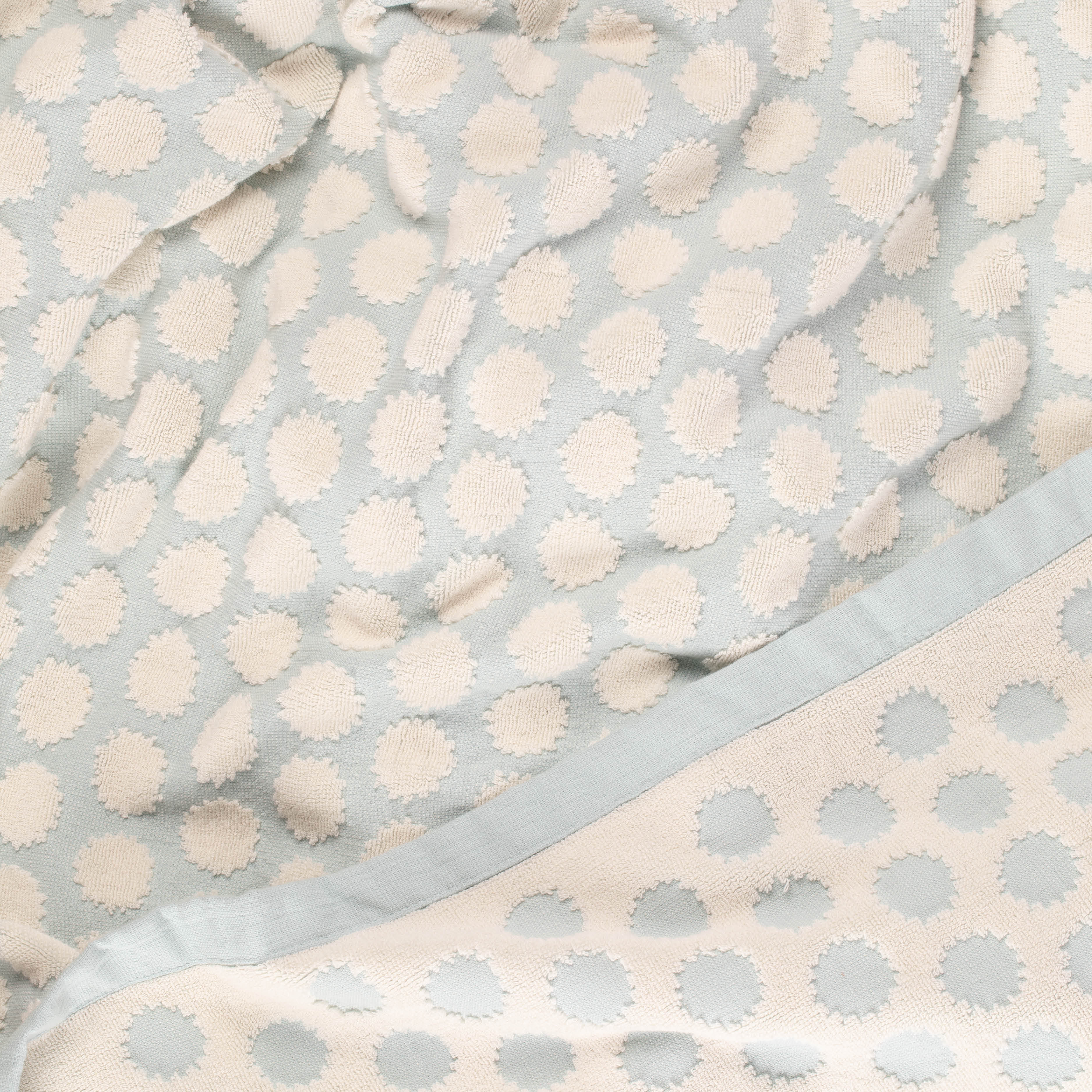 Close-up of a light blue beach towel with design by Layday