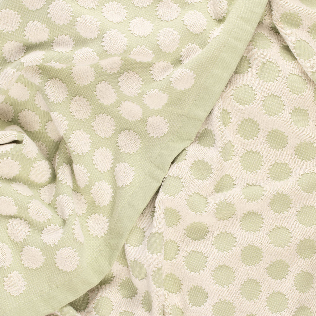 Close-up of a light green beach towel with design by Layday
