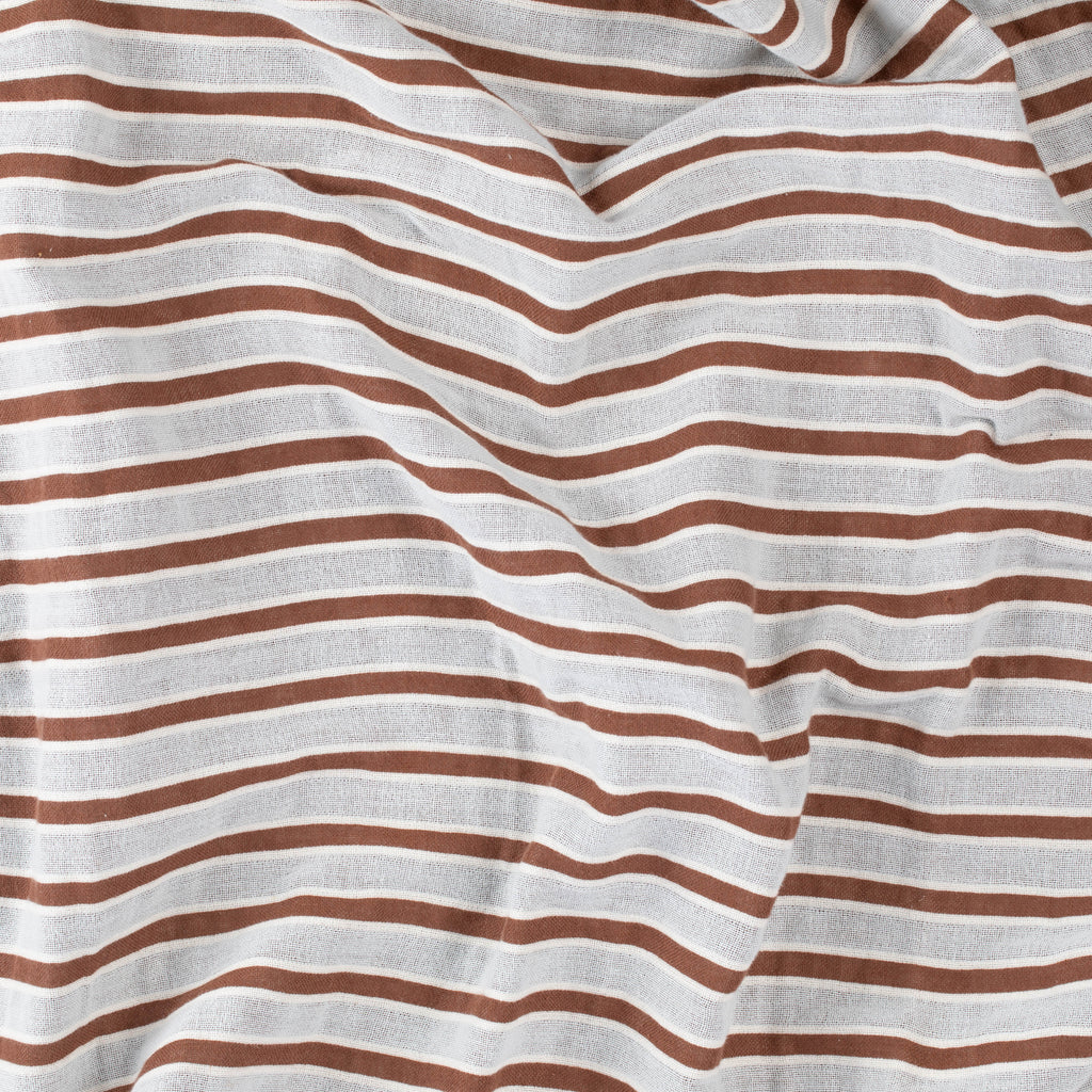 Close-up of a brown and beige striped beach towel by Layday.