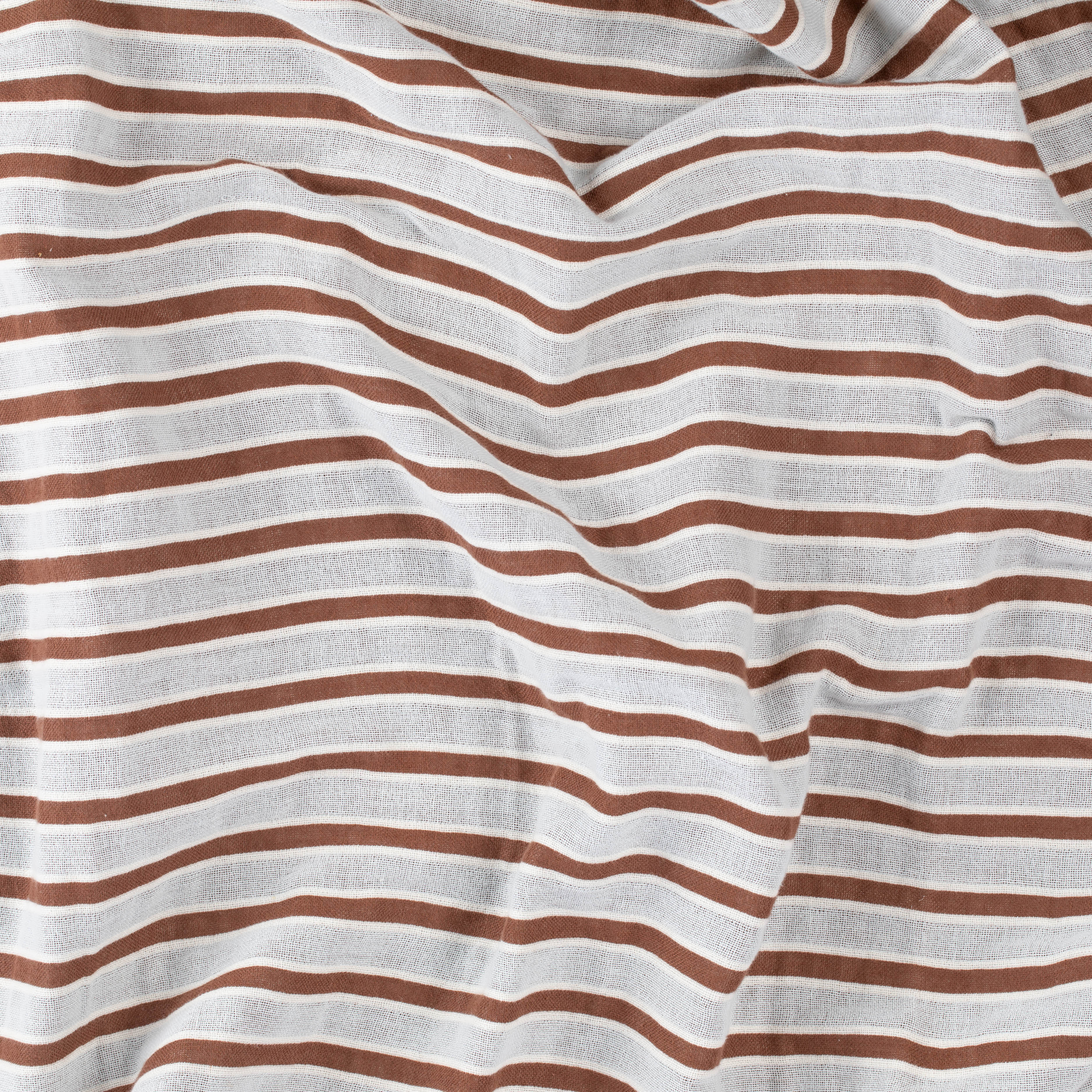 Close-up of a brown and beige striped beach towel by Layday.