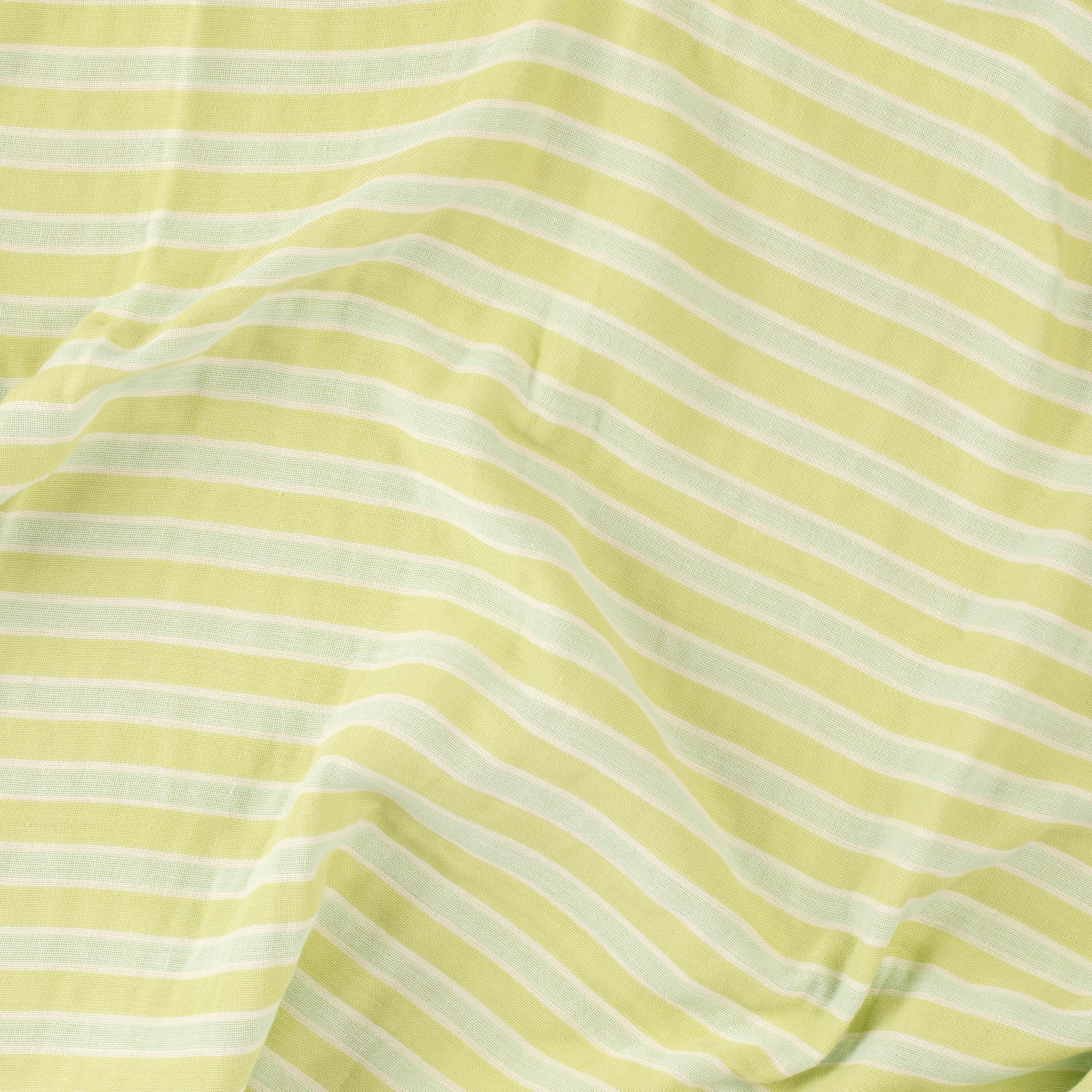 Close-up of a mint green and white striped beach towel by Layday.