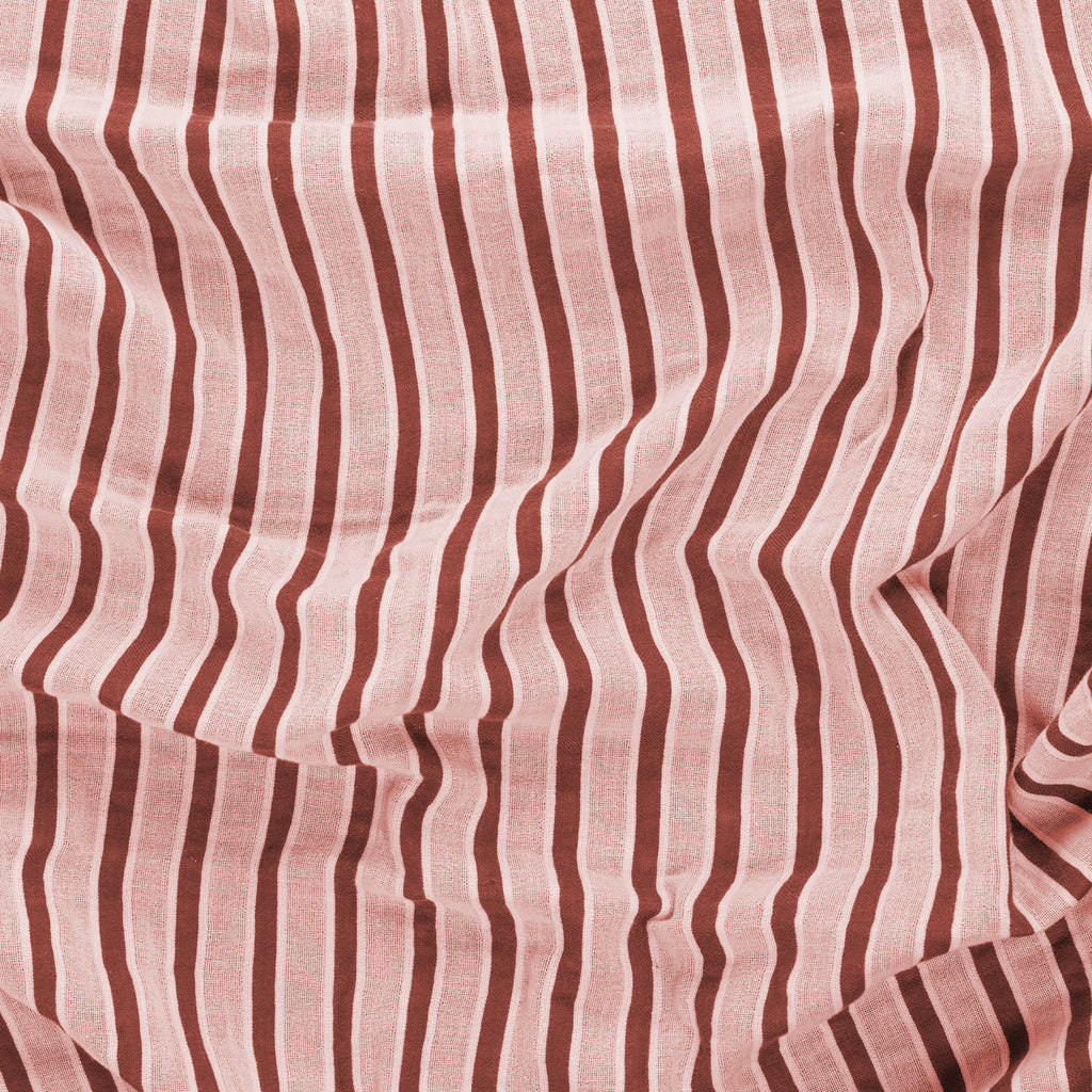 Close-up of a red and beige striped beach towel by Layday.