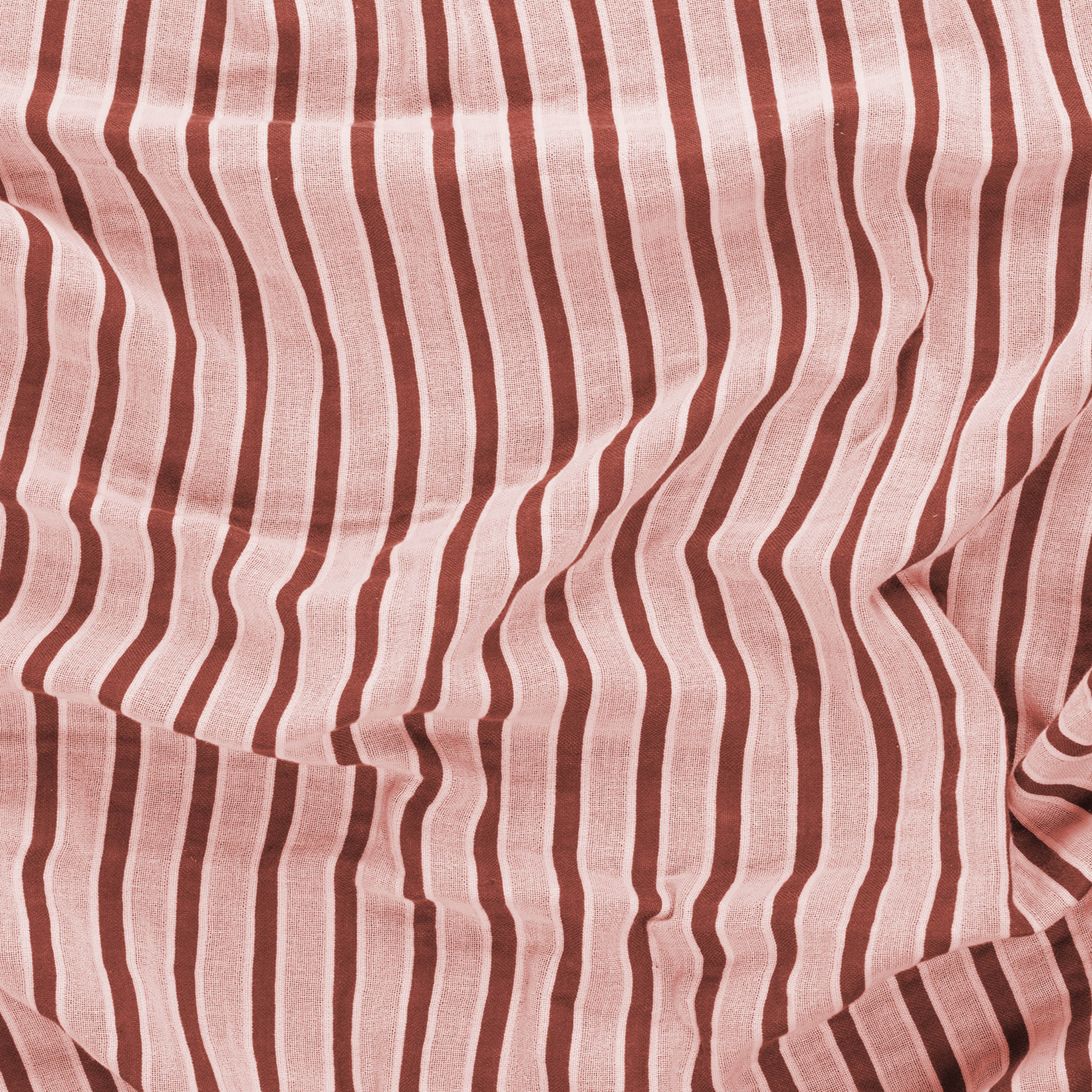 Close-up of a red and beige striped beach towel by Layday.