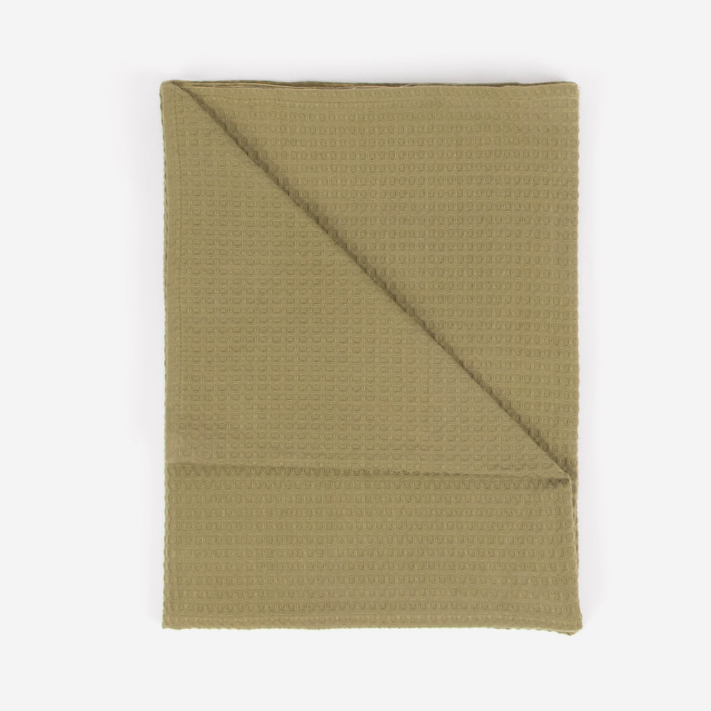An olive green colored beach towel by Layday