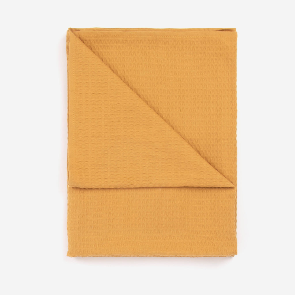 A honey colored beach towel by Layday