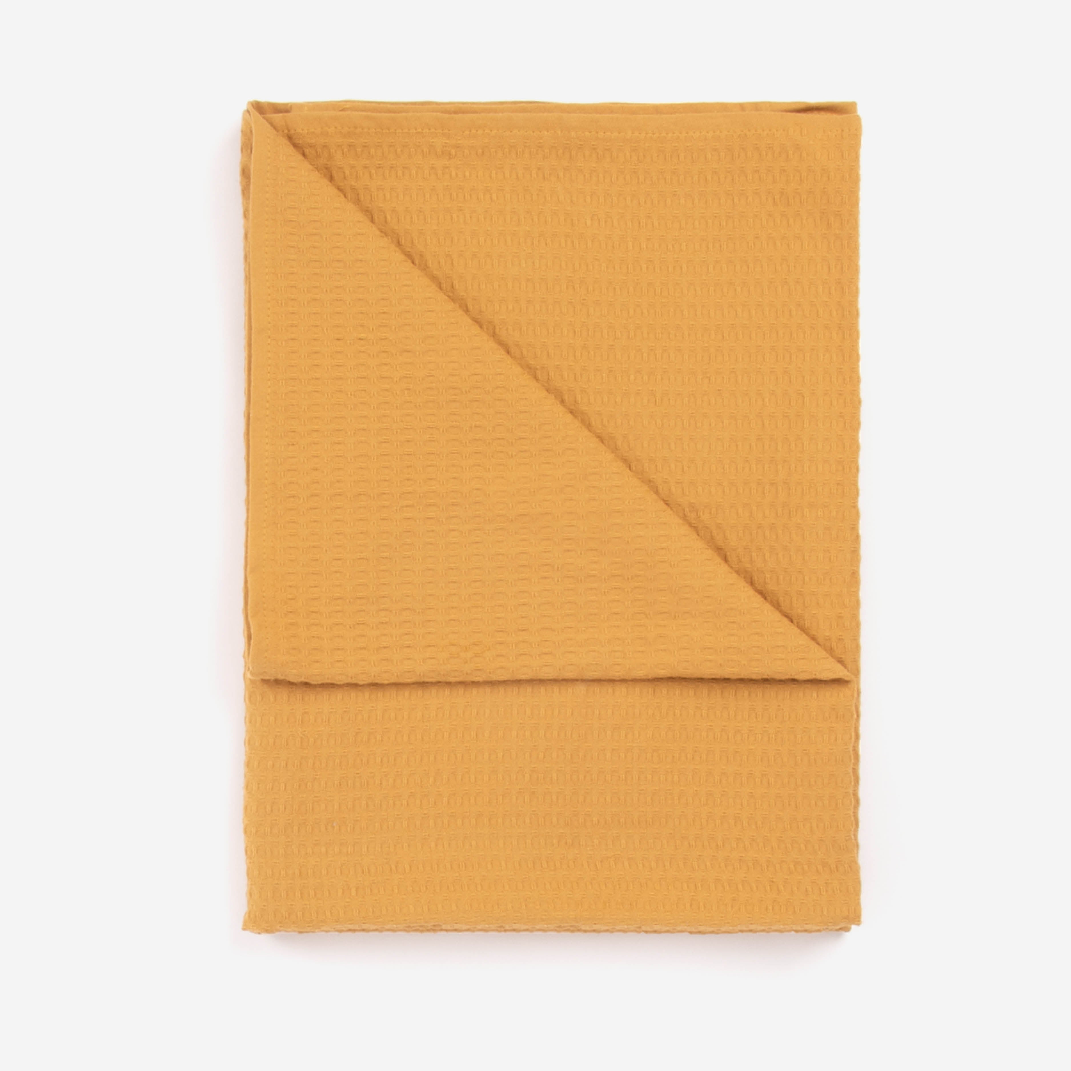 A honey colored beach towel by Layday
