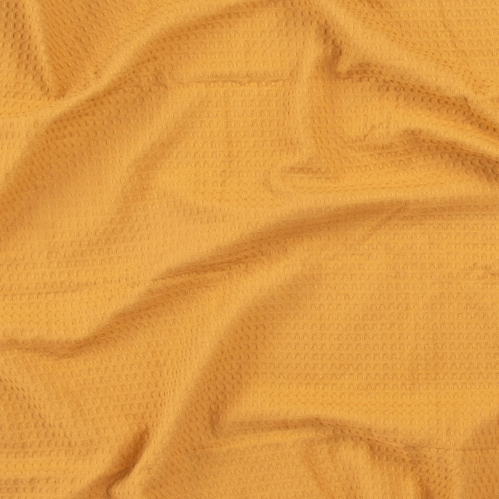 Close-up of a honey colored beach towel by Layday