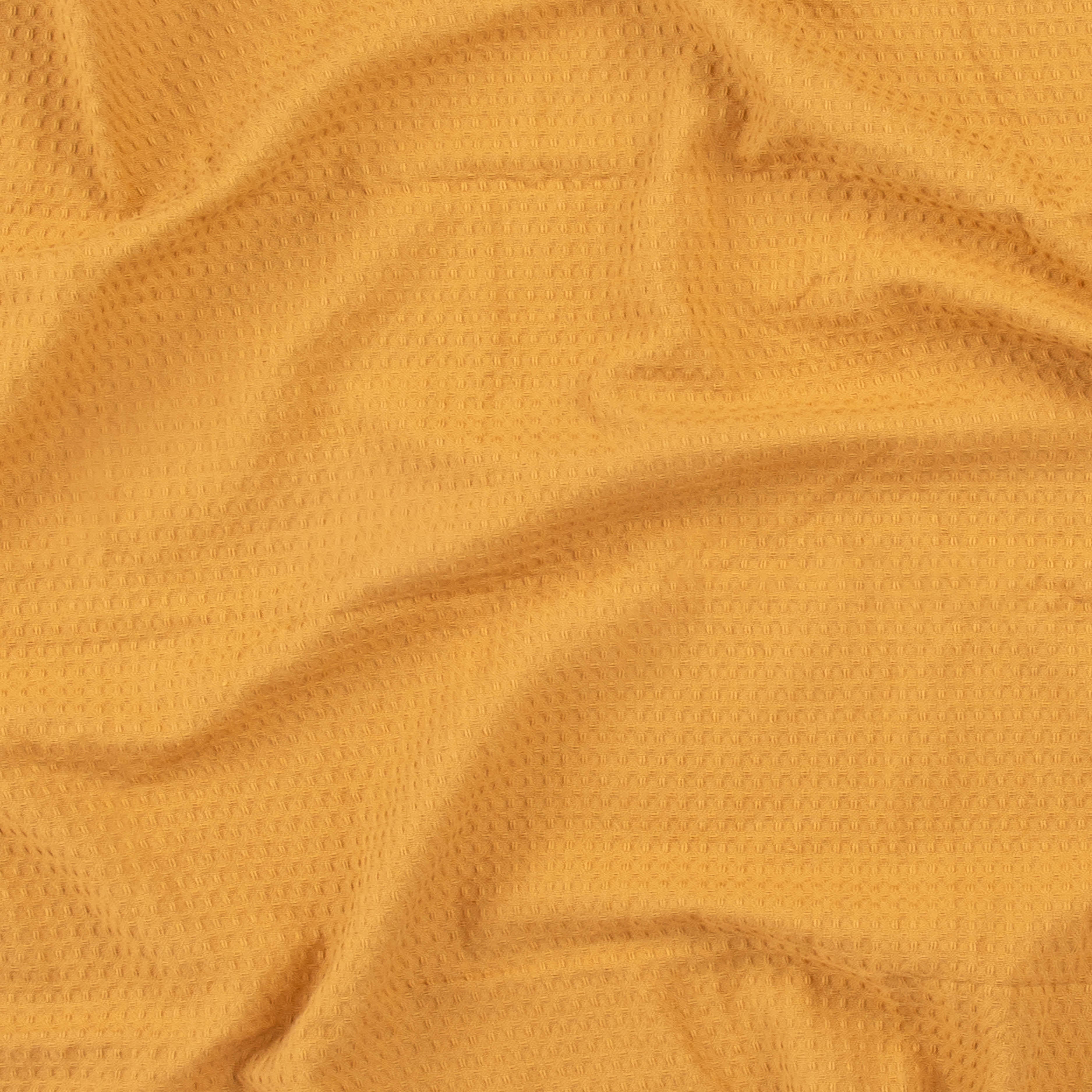 Close-up of a honey colored beach towel by Layday