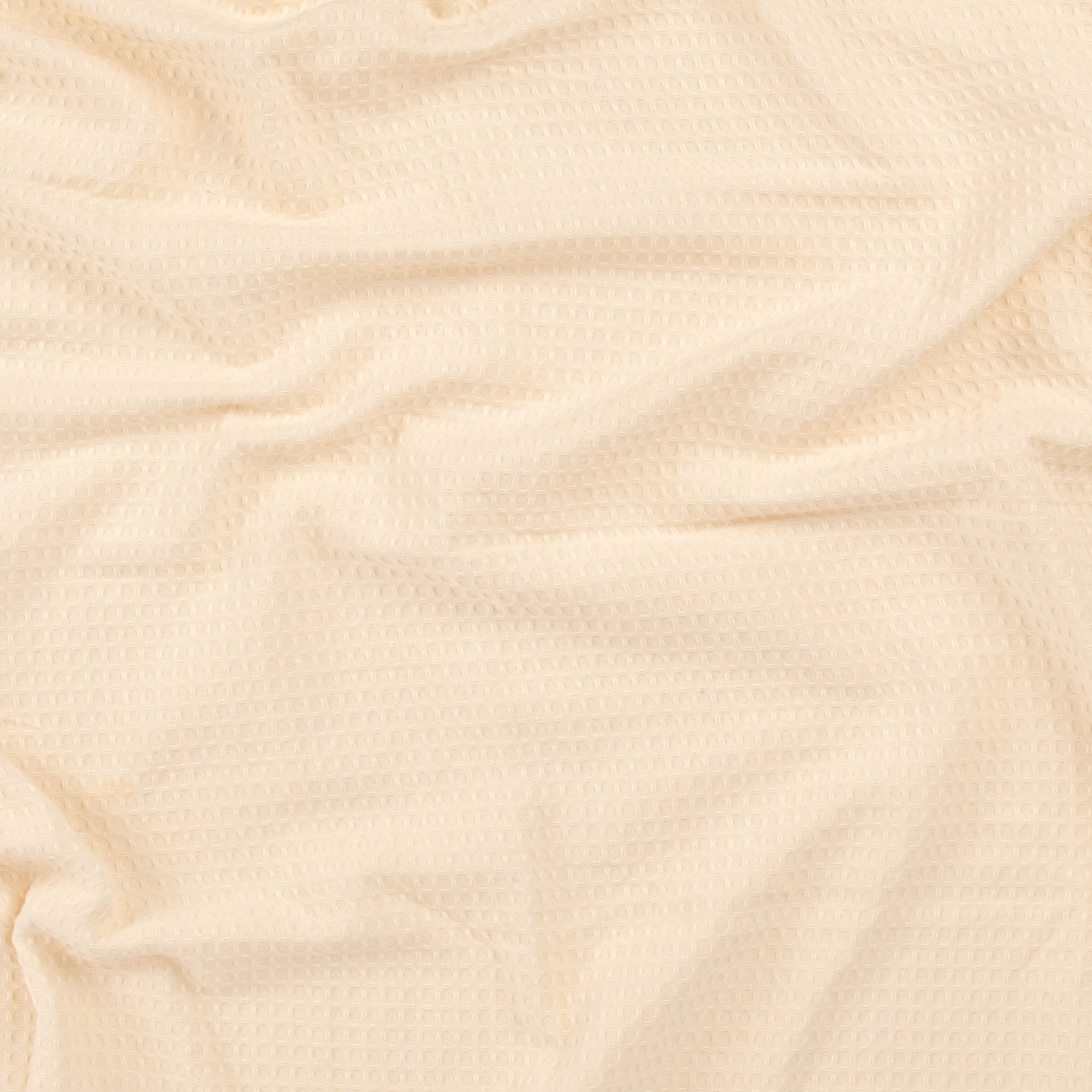 Close-up of a sand colored beach towel from Layday