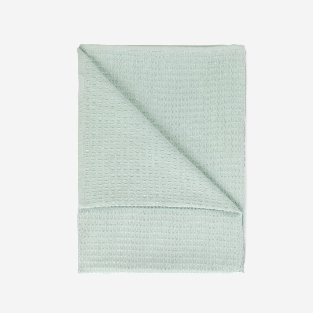 A mint colored beach towel by Layday