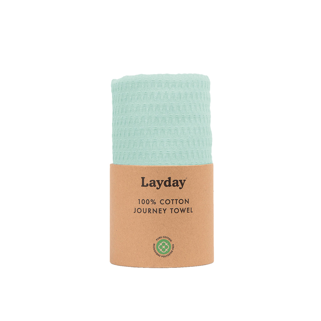 A mint colored beach towel by Layday