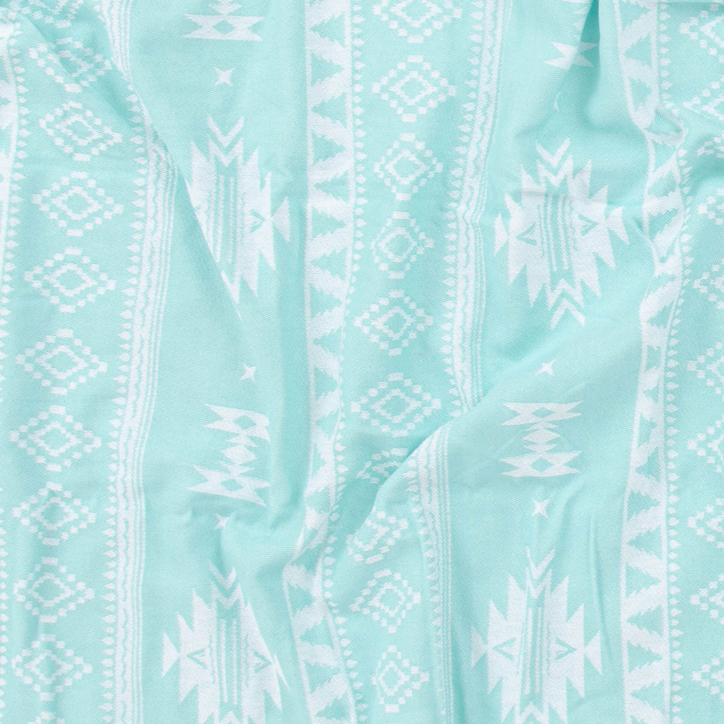Close-up of light blue fabric with white geometric pattern
