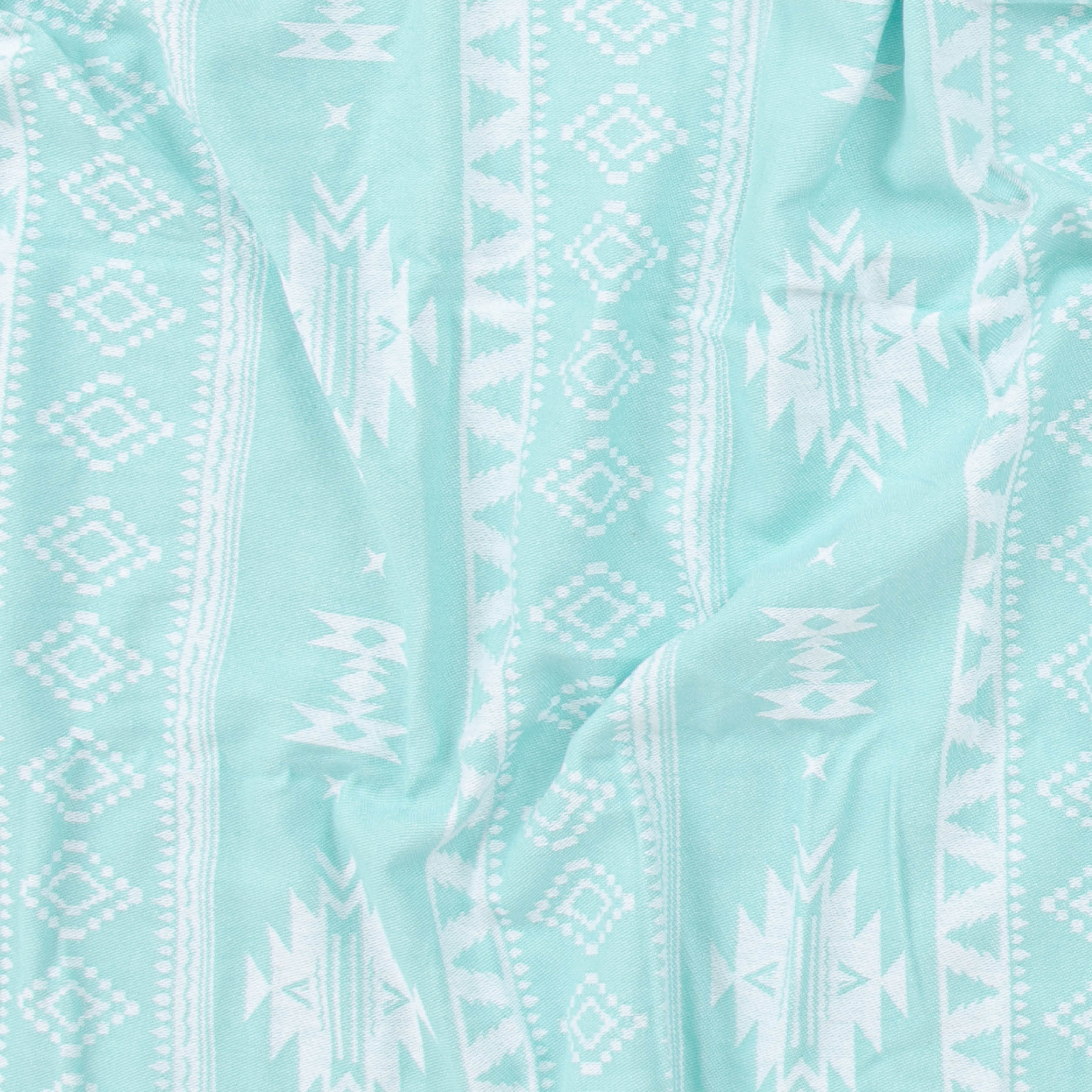 Close-up of light blue fabric with white geometric pattern