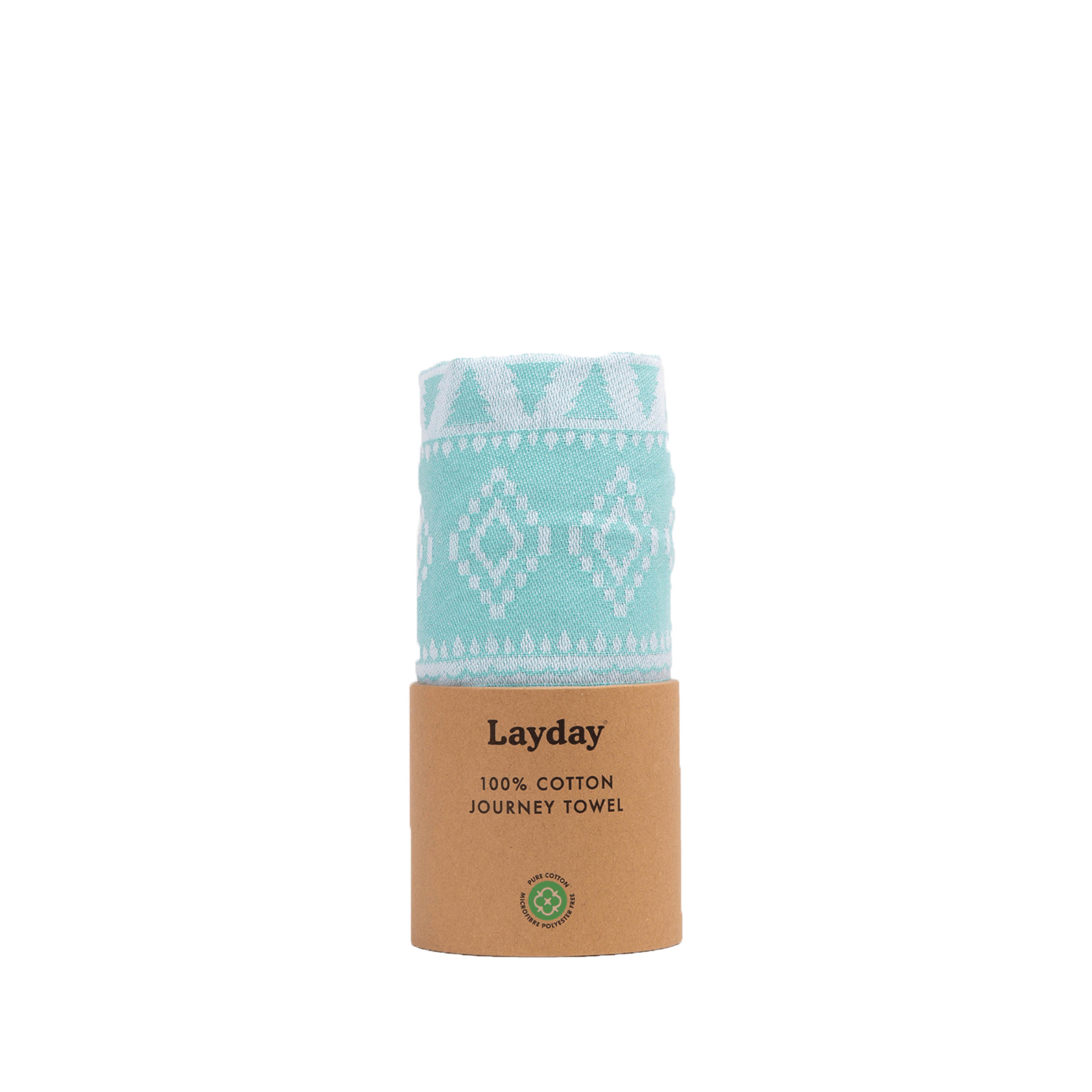 Teal towel with white patterns in a cardboard holder labeled 'Layday' on a white background