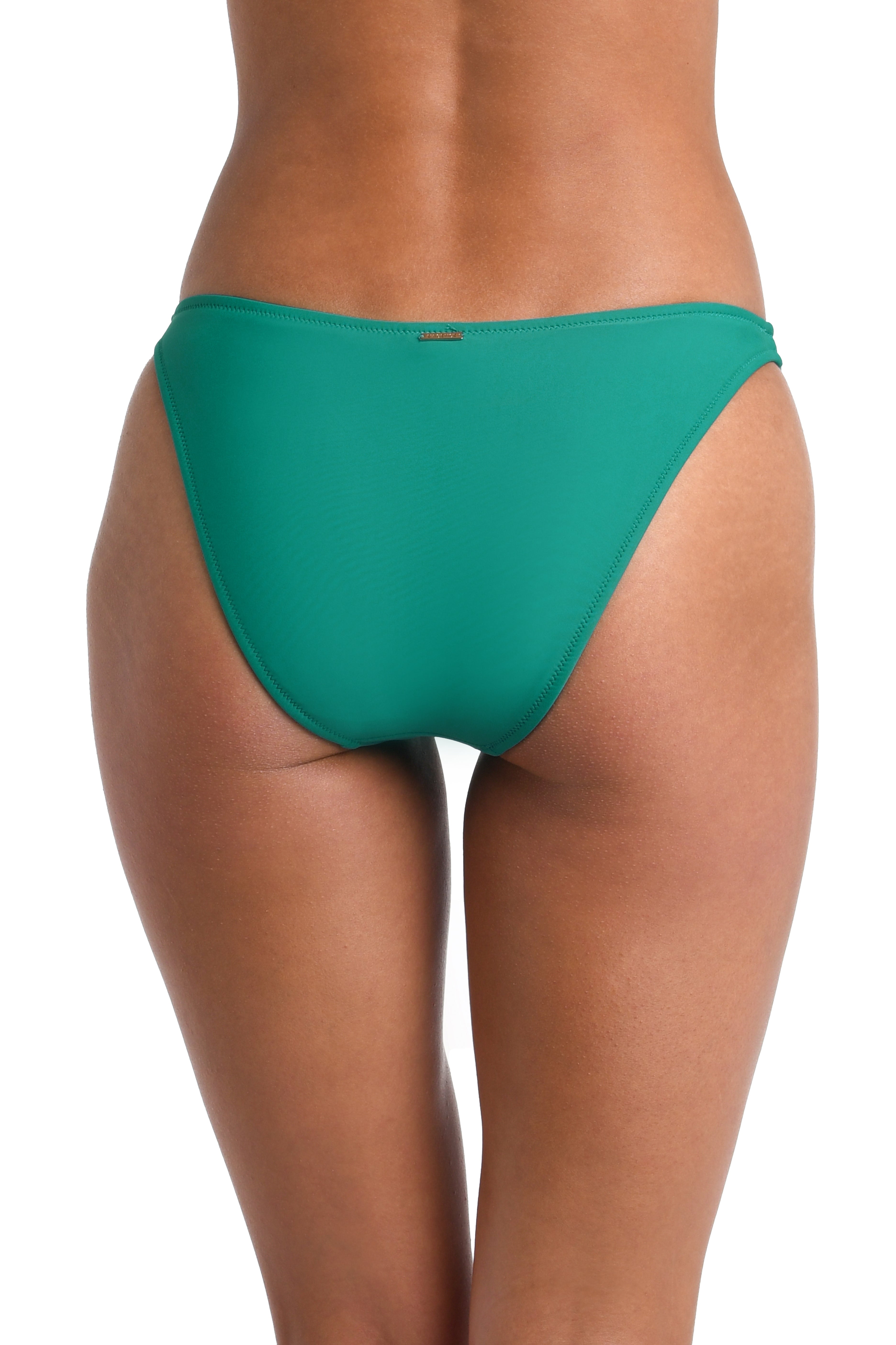 Woman wearing a solid emerald green hipster bikini bottom against a white background.