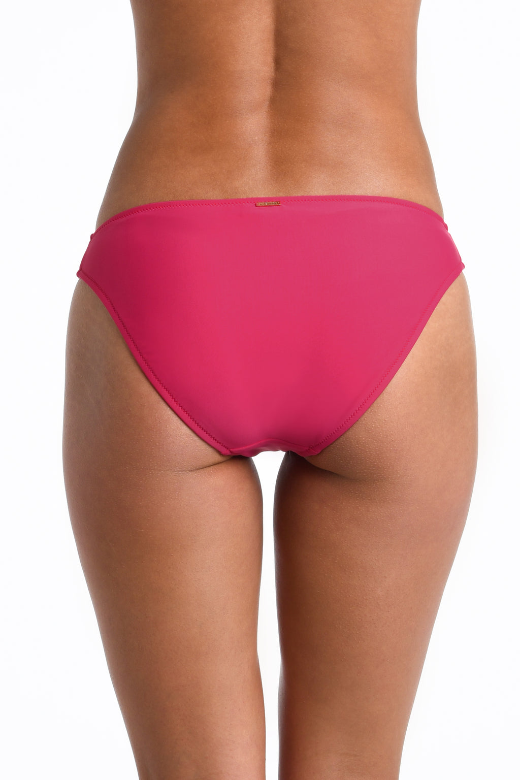 Rear view of a model wearing bright pink bikini bottoms against a plain white background.