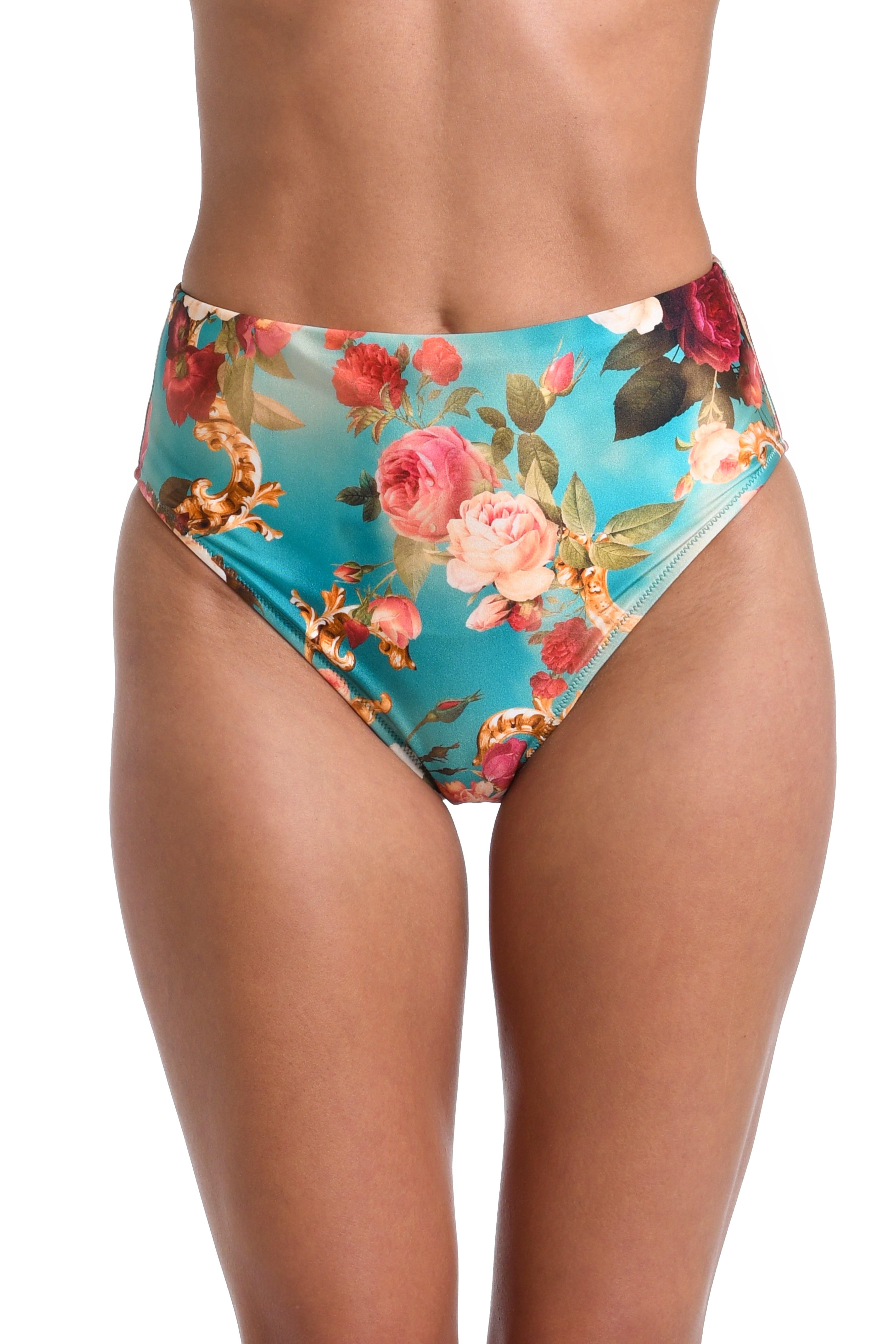 A close-up of a model wearing high-waisted bikini bottoms with a vibrant turquoise blue background and a detailed floral print featuring pink, red, and peach roses with green leaves.