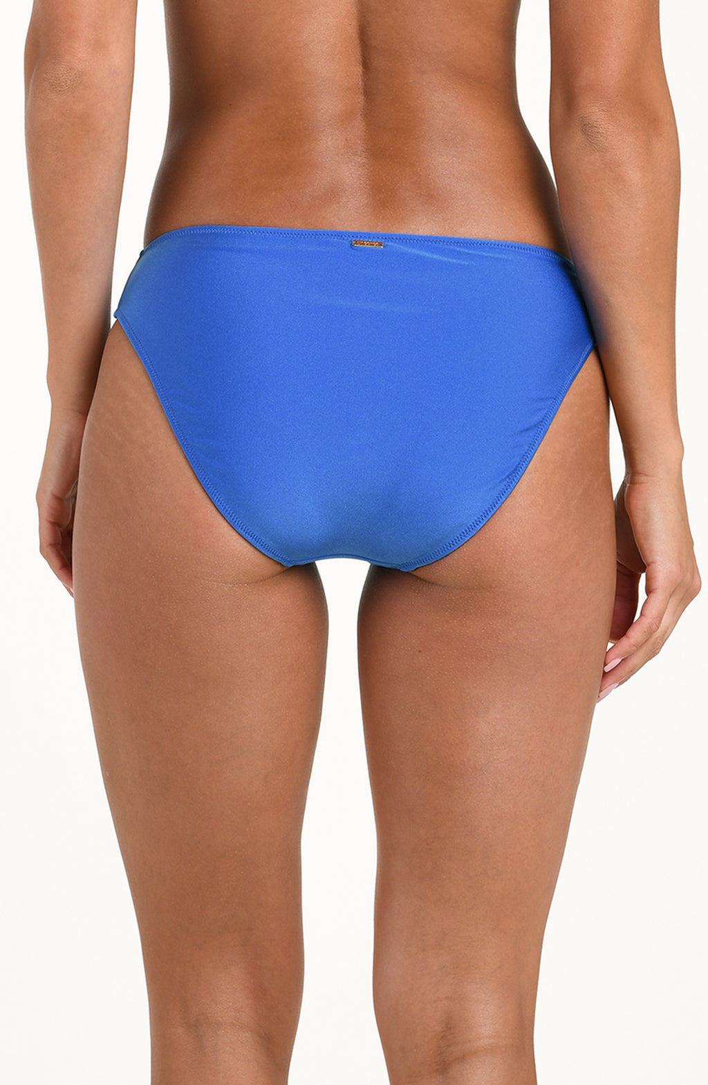 Blue bikini bottom worn by a person on a white background