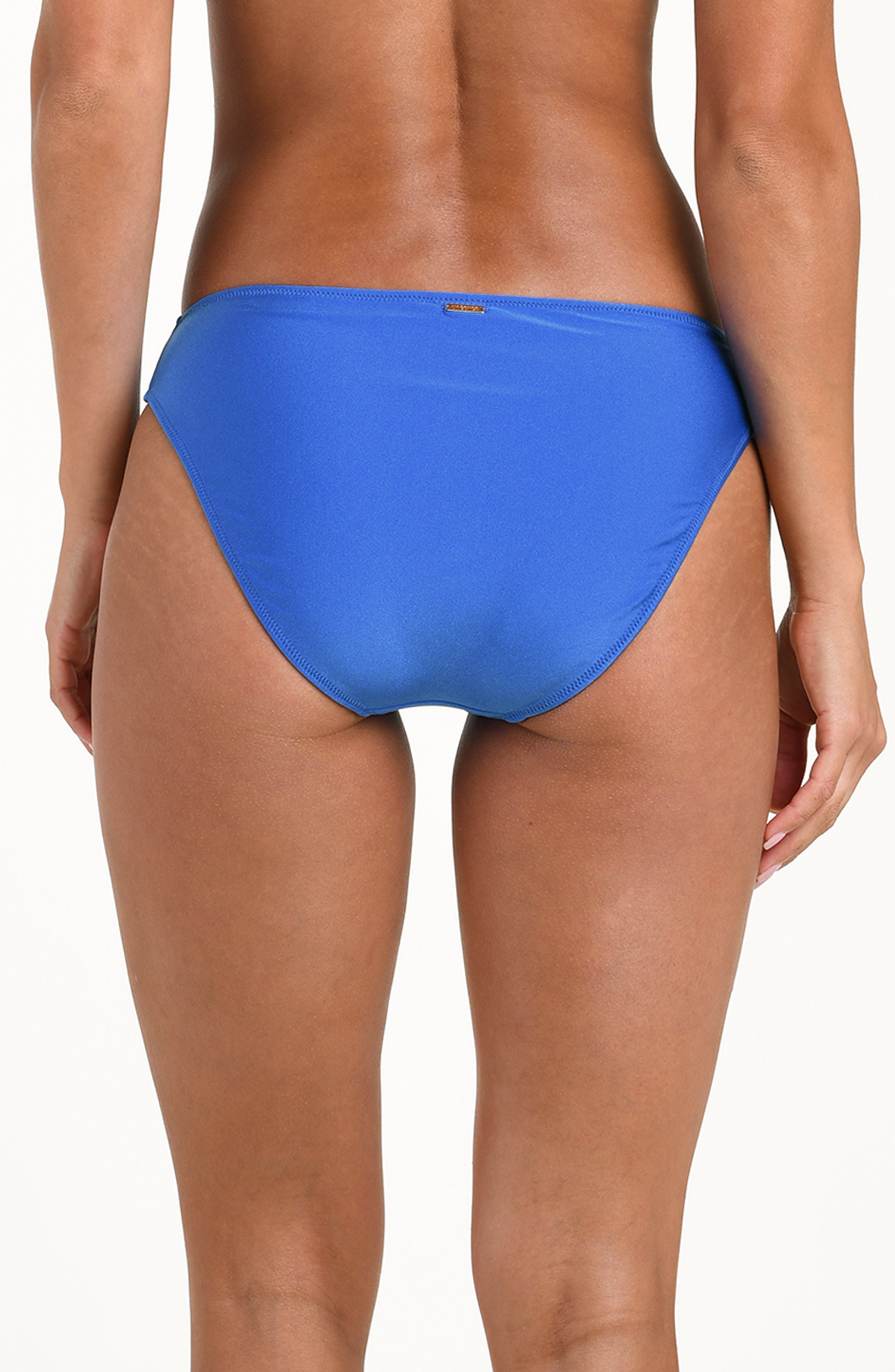 Blue bikini bottom worn by a person on a white background