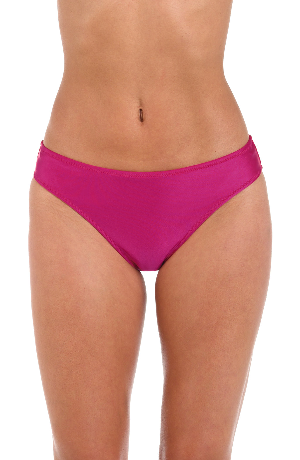 Woman wearing a fuchsia colored hipster bikini bottom against a white background. 
