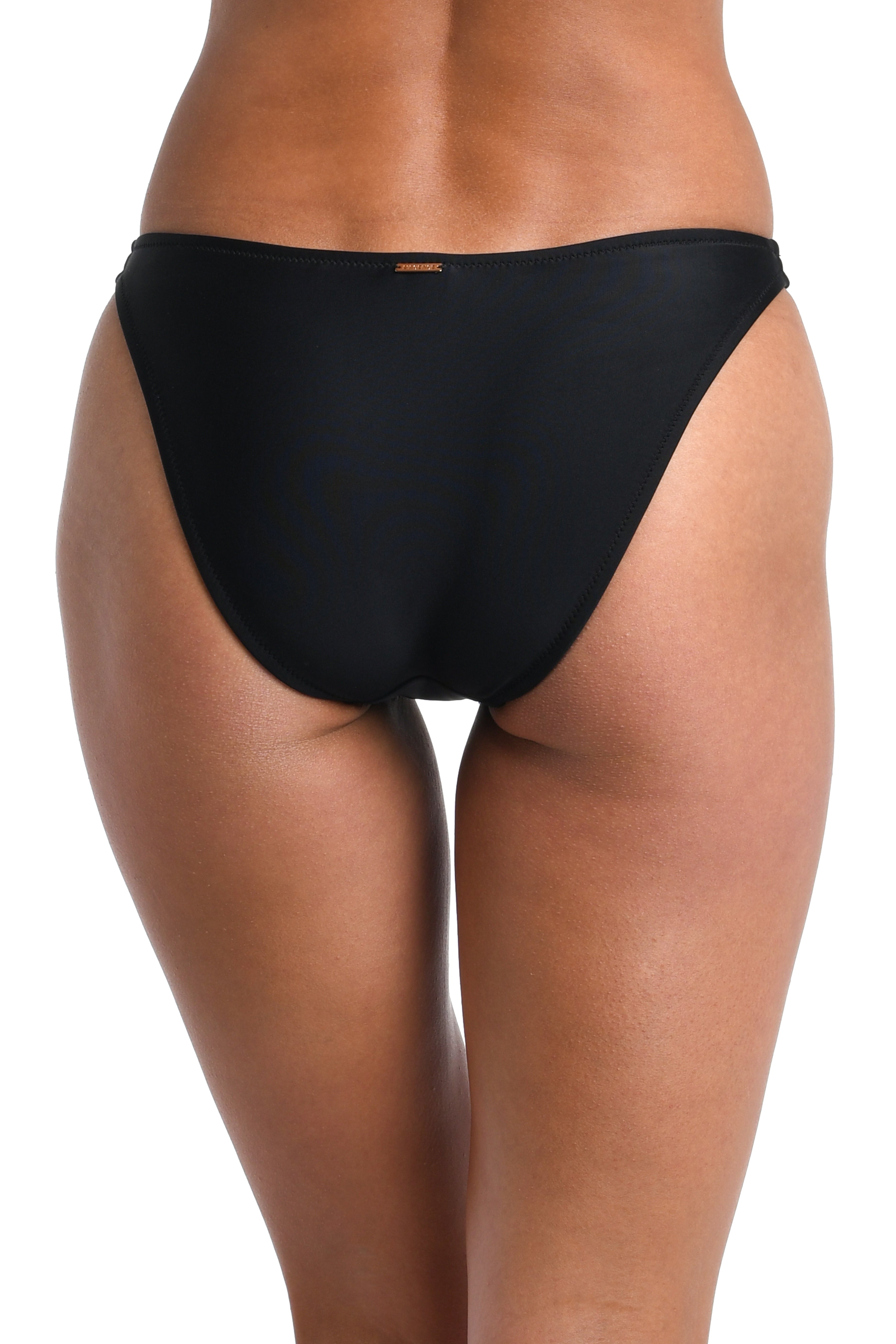 Black bikini bottom worn by a person on a white background