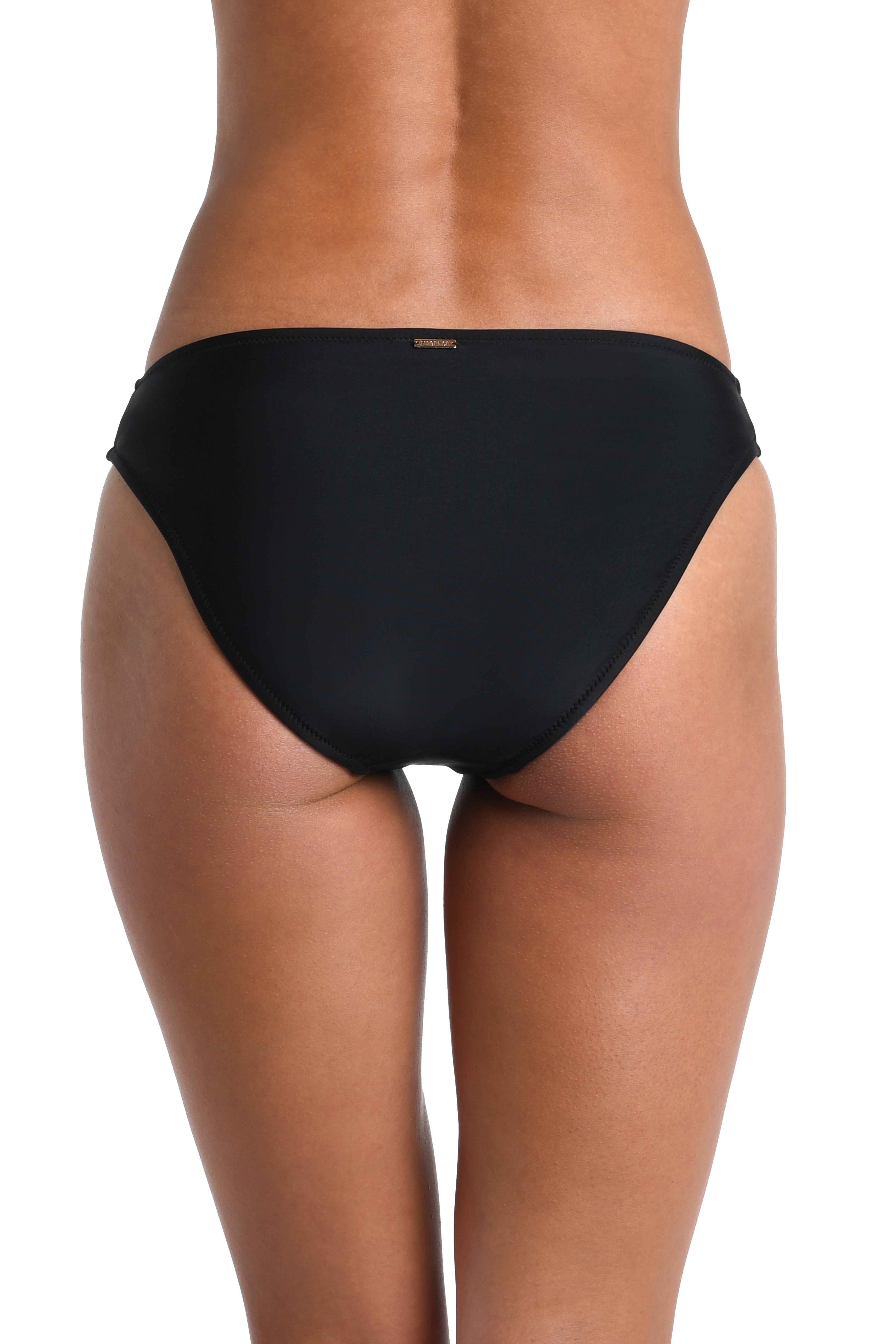 Black bikini bottom worn by a person on a white background
