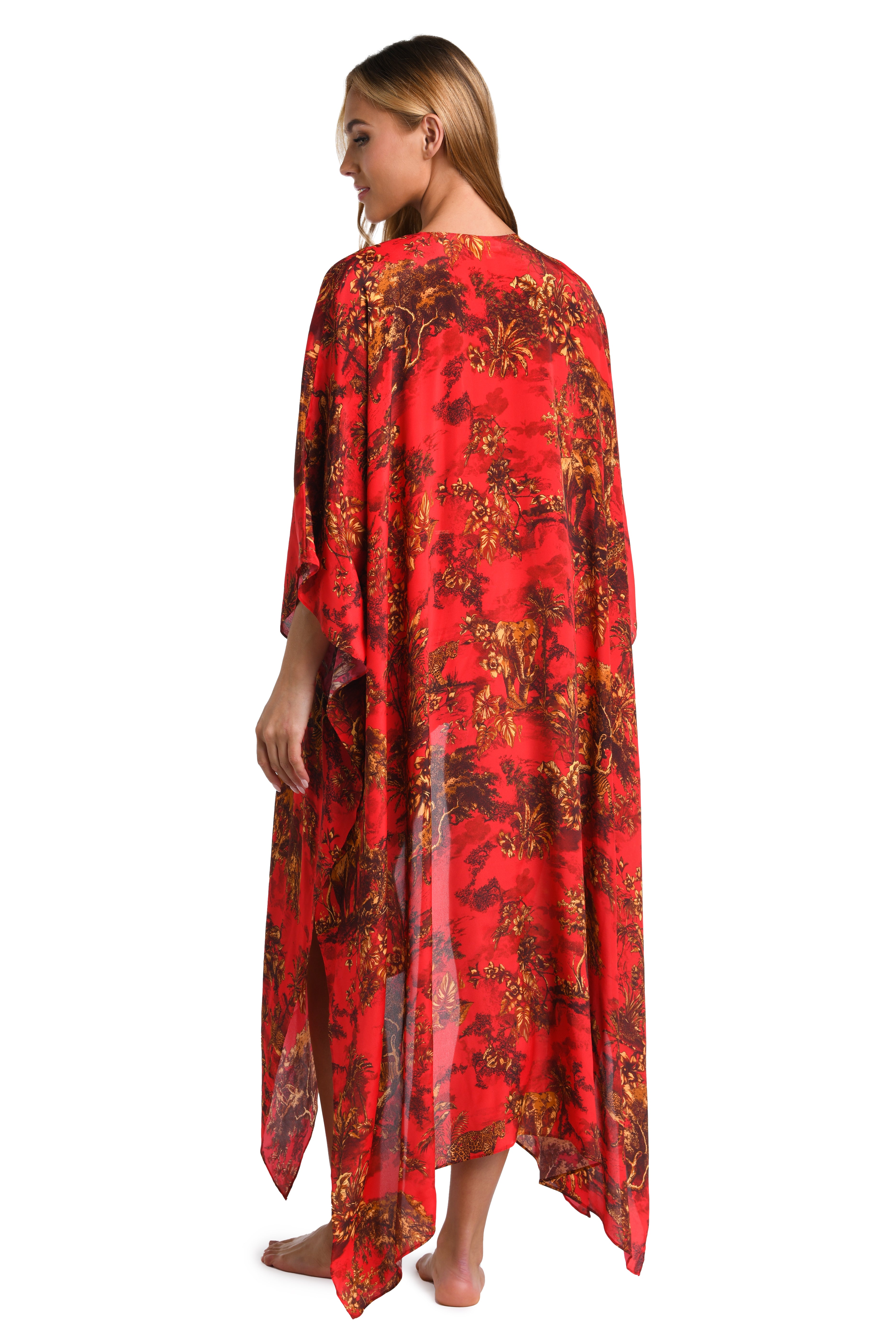 Woman wearing a red multicolored kimono and matching swimsuit set against a white background. 