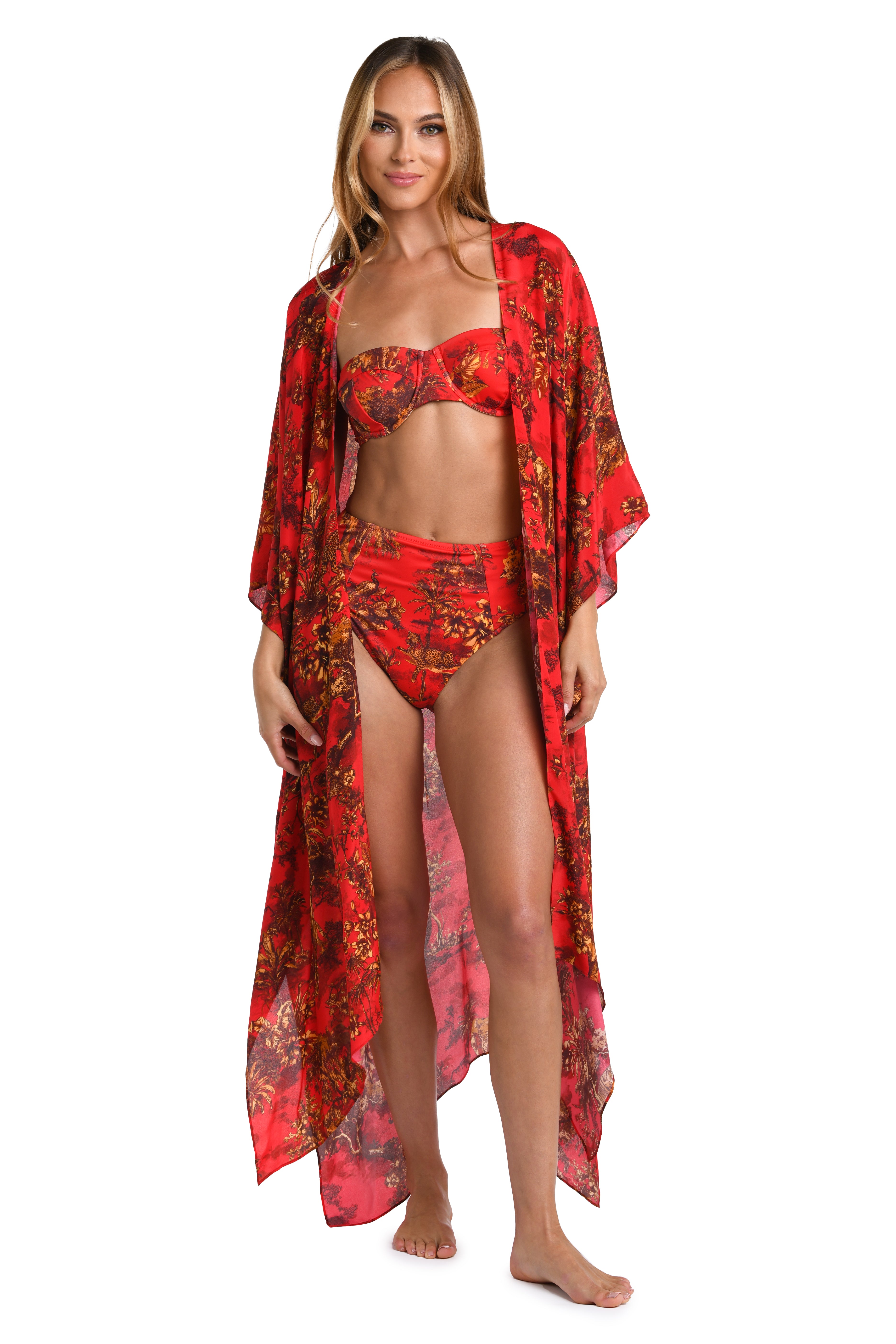 Woman wearing a red multicolored kimono and matching swimsuit set against a white background. 