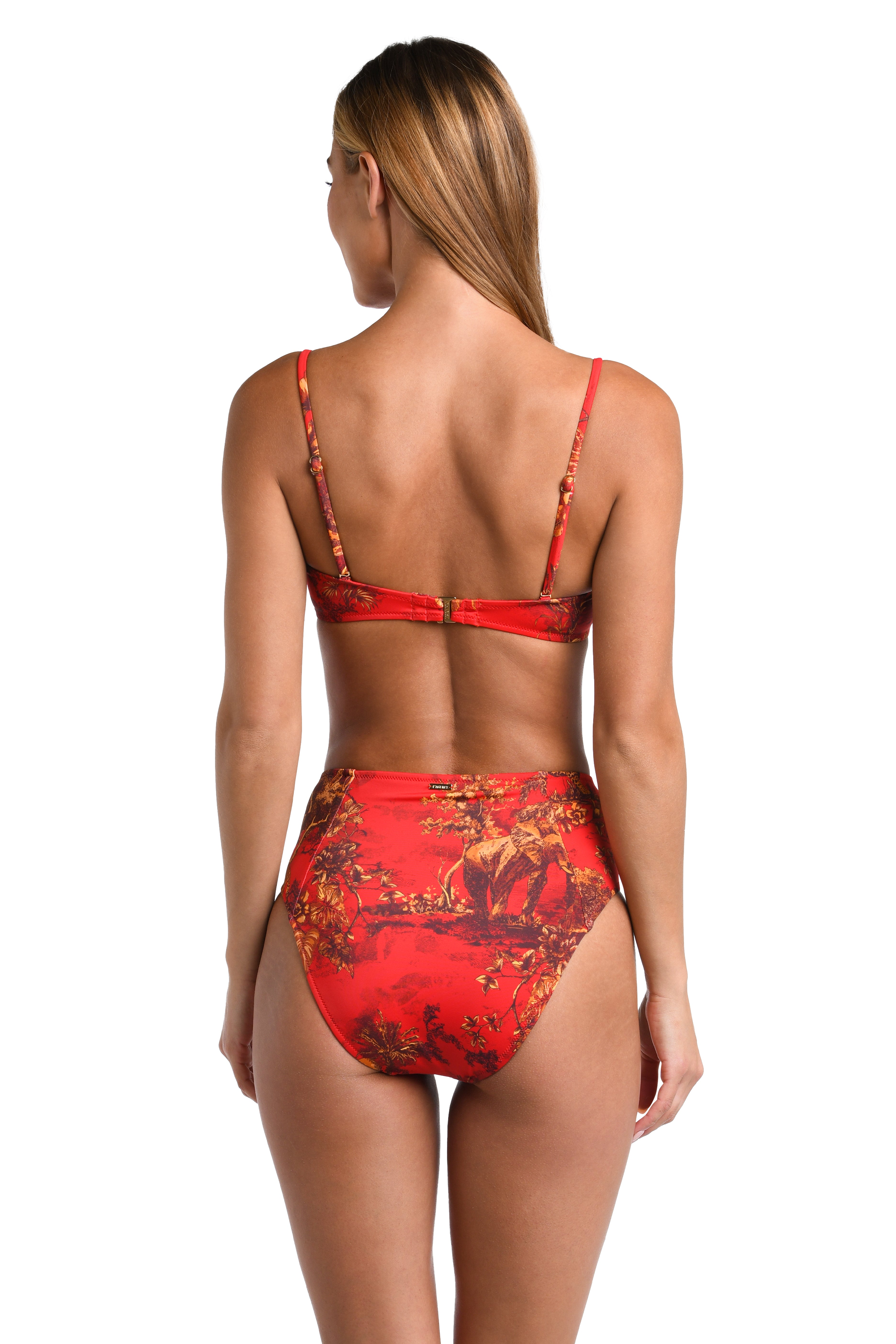 A woman shown from the back wearing a red bikini with a floral print, set against a plain white background.
