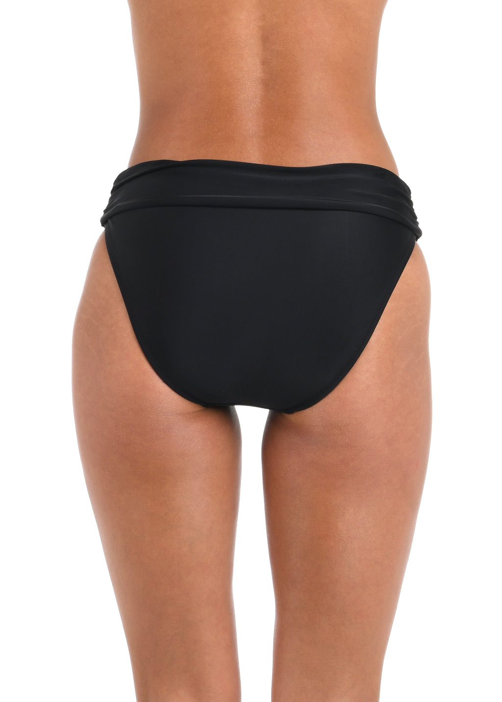 Black bikini bottom worn by a person on a white background