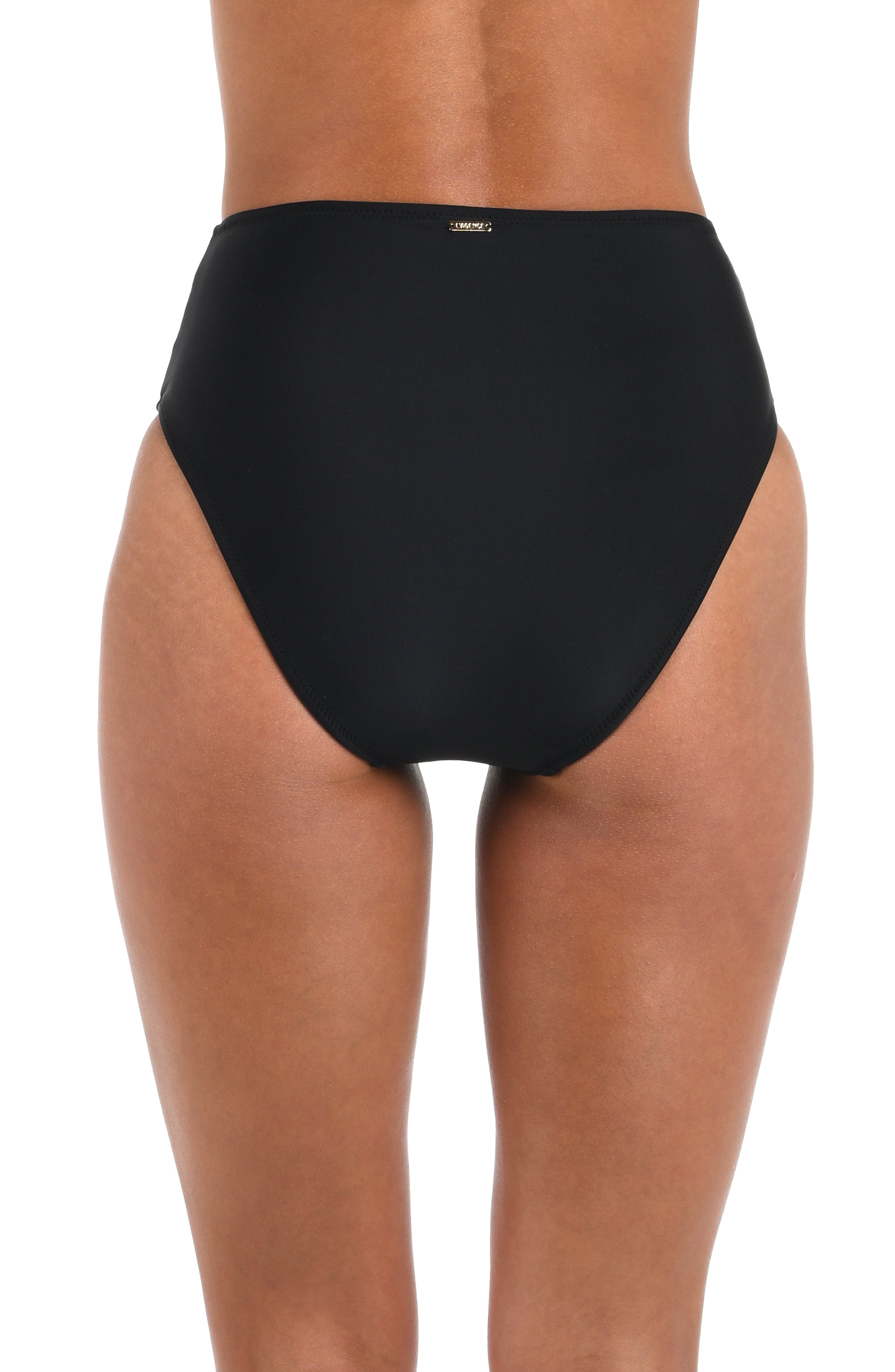 Back image of model wearing a solid black bikini bottom featuring a high waistline and moderate coverage in the back adorned with a gold logo plate.