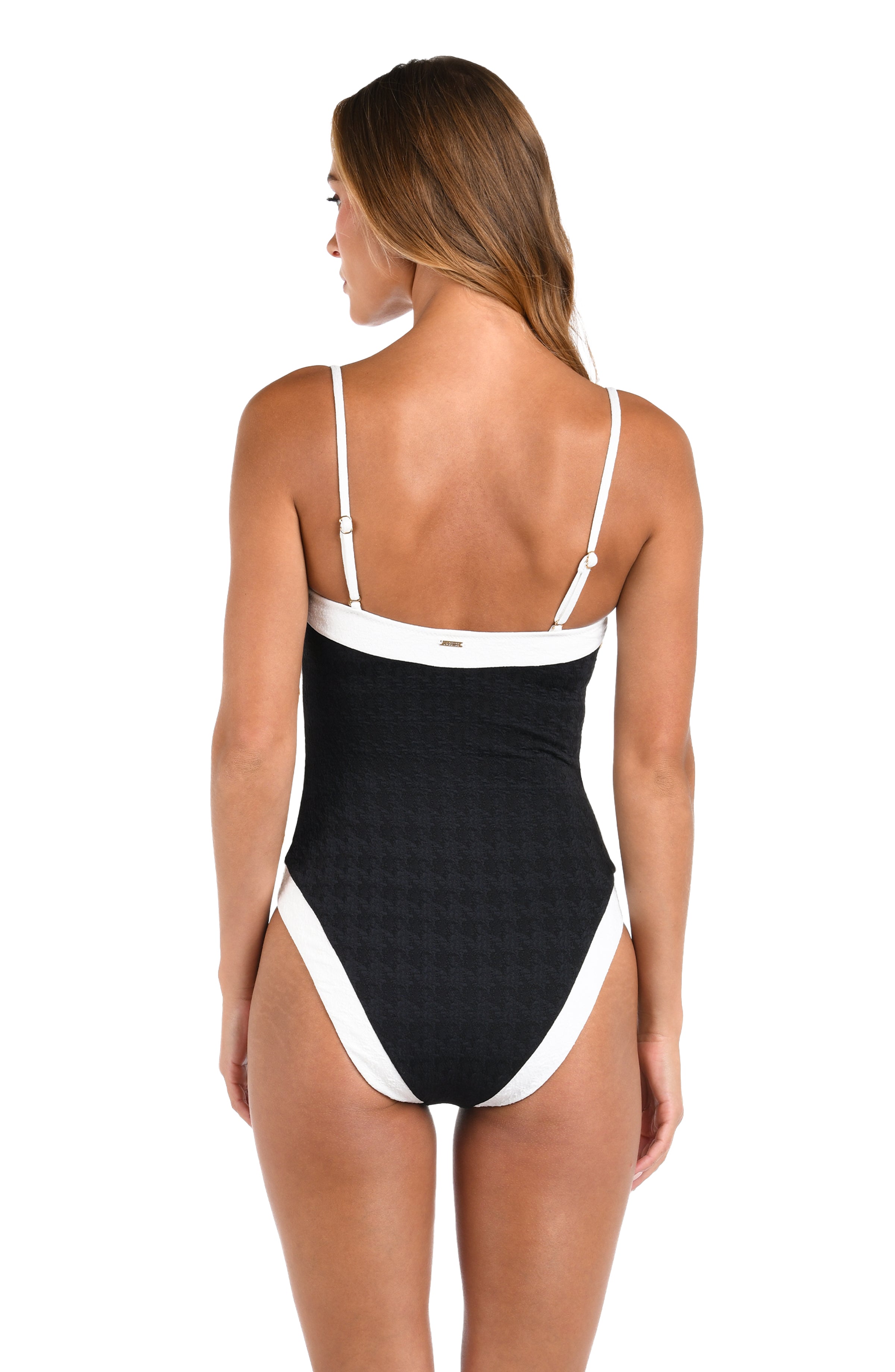 Woman wearing a black and white swimsuit on a white background