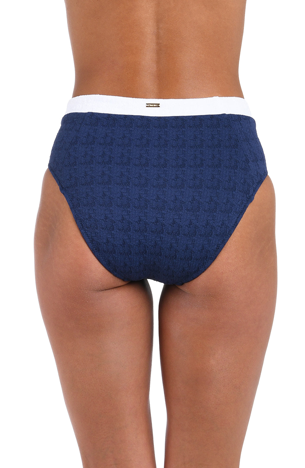 Rear view of a model wearing high-waisted navy blue textured briefs with a white waistband.