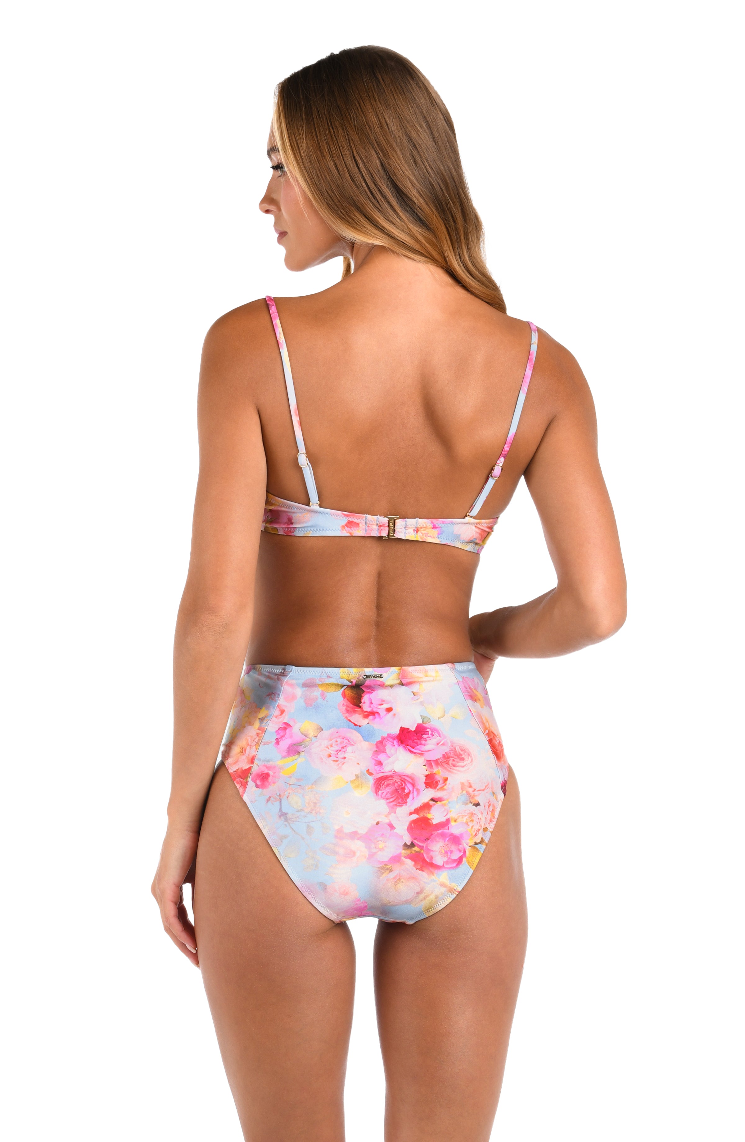 Woman wearing a multicolored floral bikini top and matching bottom against a white background. 