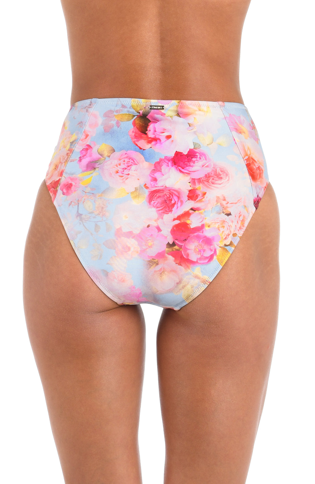 Woman wearing a light multicolored floral printed high waisted bikini bottom against a white background. 