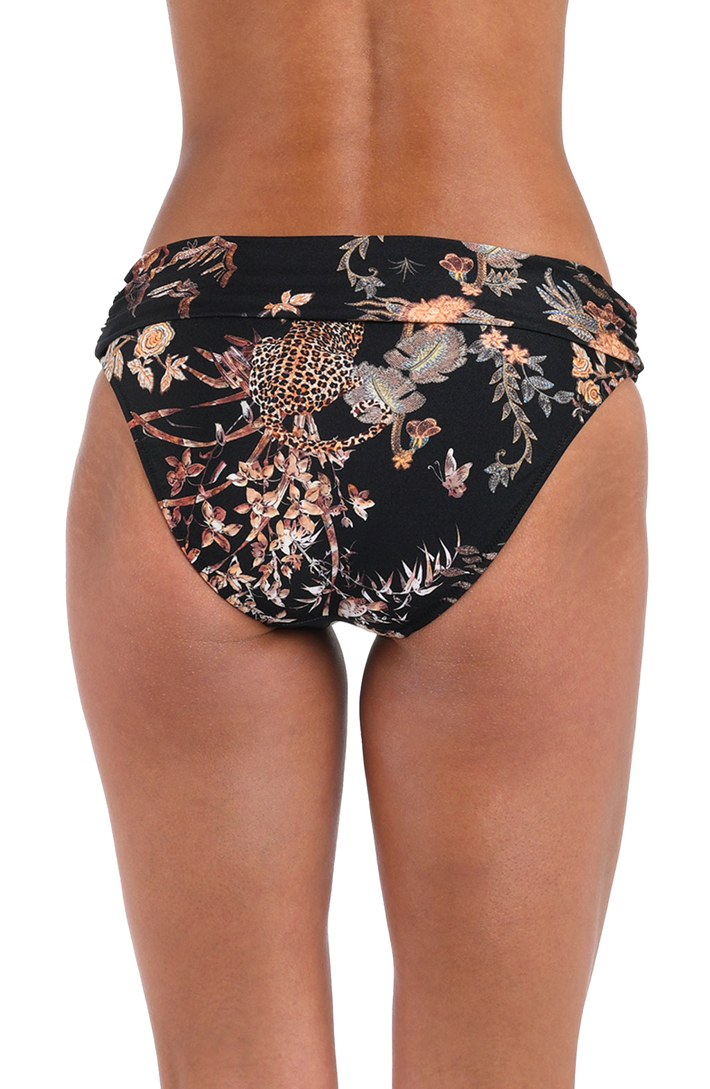 Woman wearing a black multicolored bikini bottom against a white background. 
