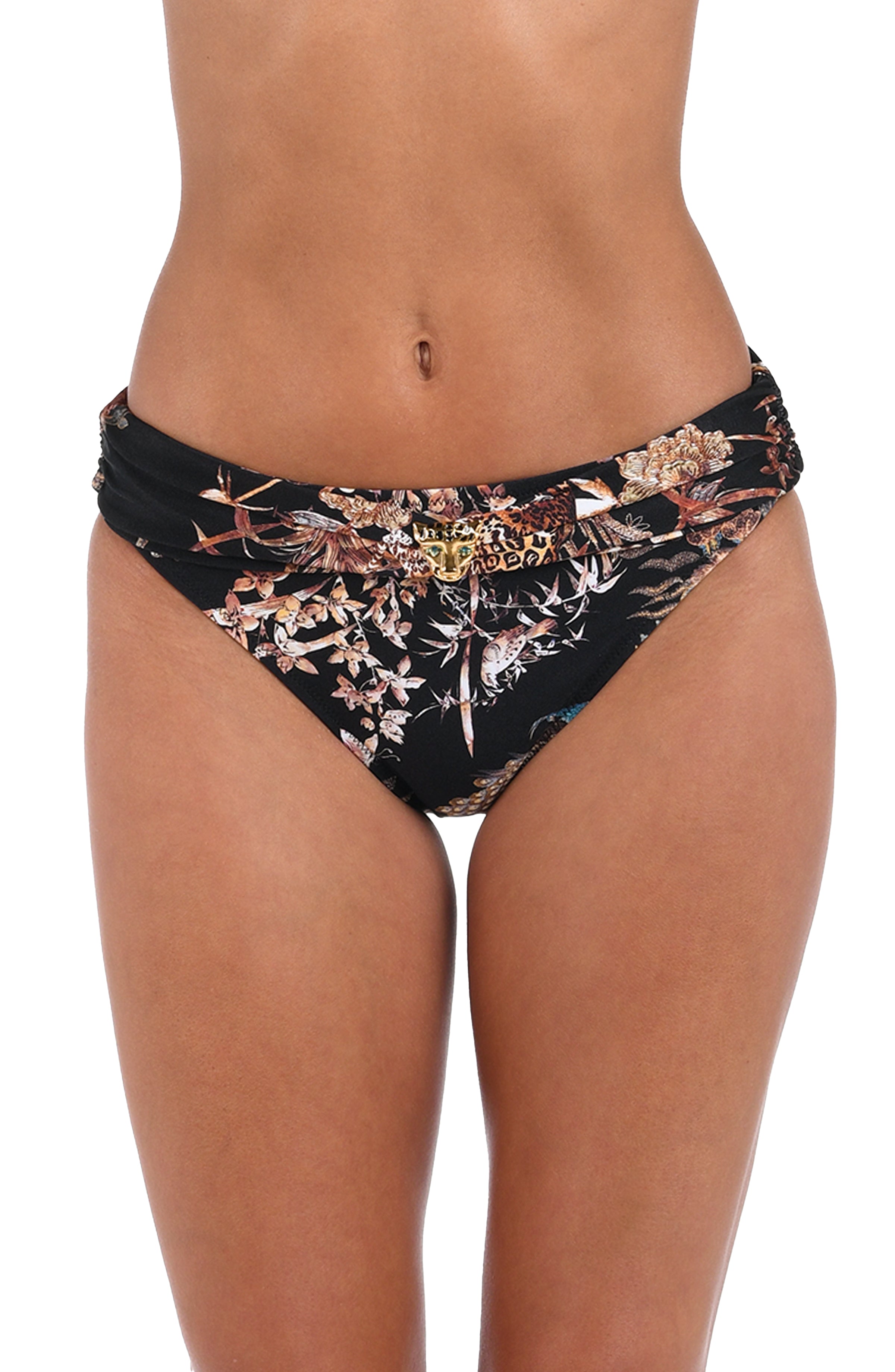 Woman wearing a black multicolored bikini bottom against a white background. 