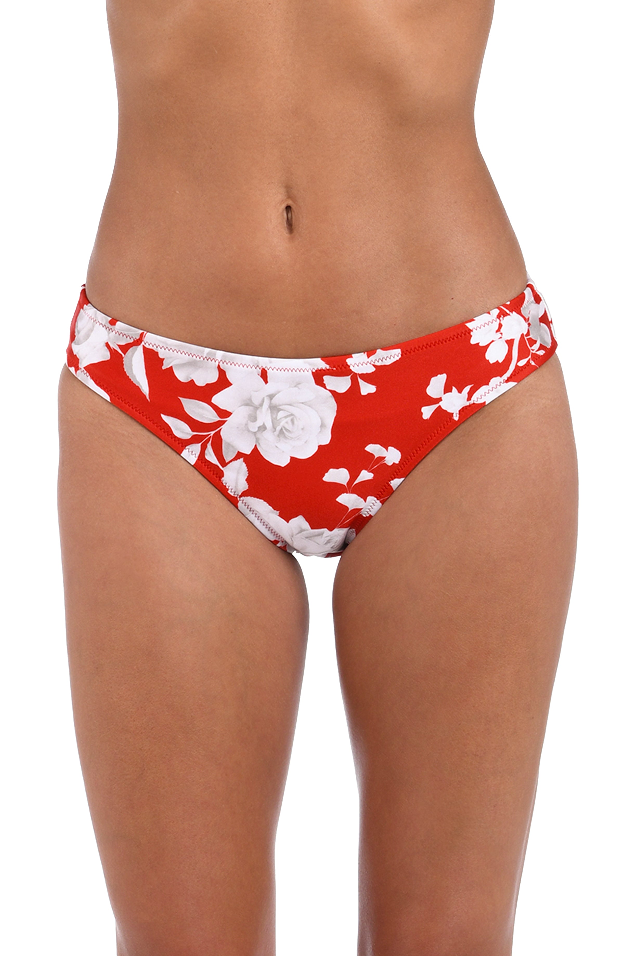 Woman wearing a red and white multicolored tropical printed hipster bikini bottom against a white background. 