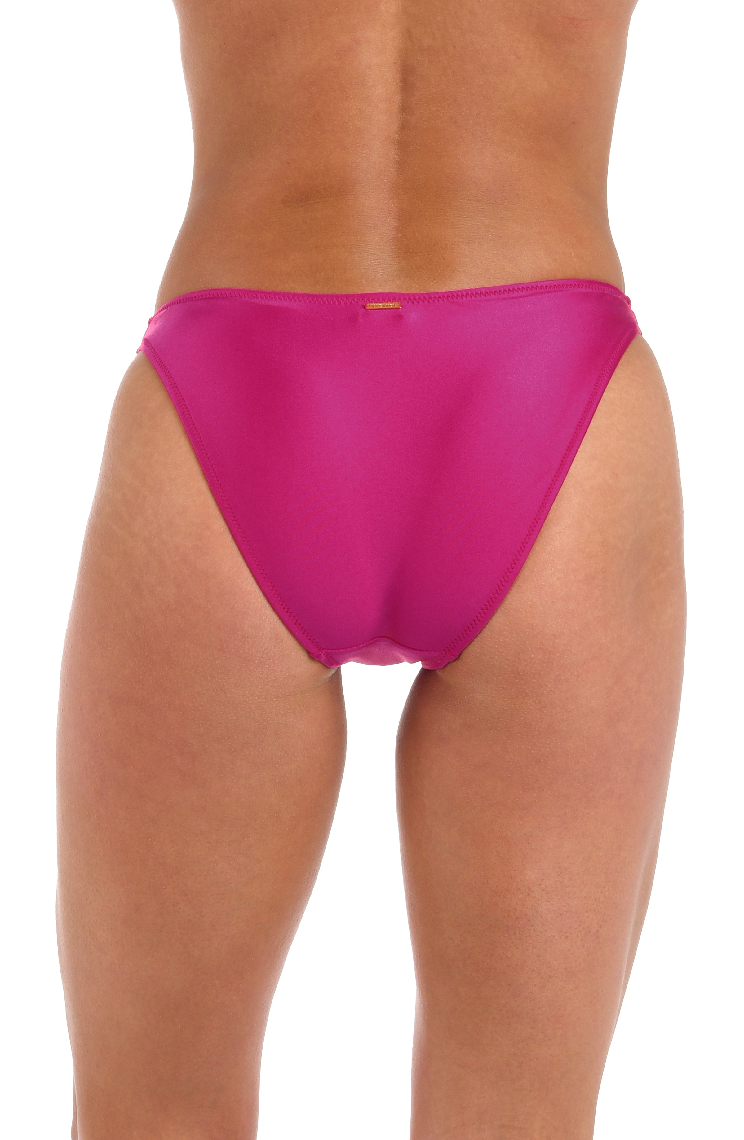 Woman wearing a solid fuchsia high leg bikini bottom against a white background.