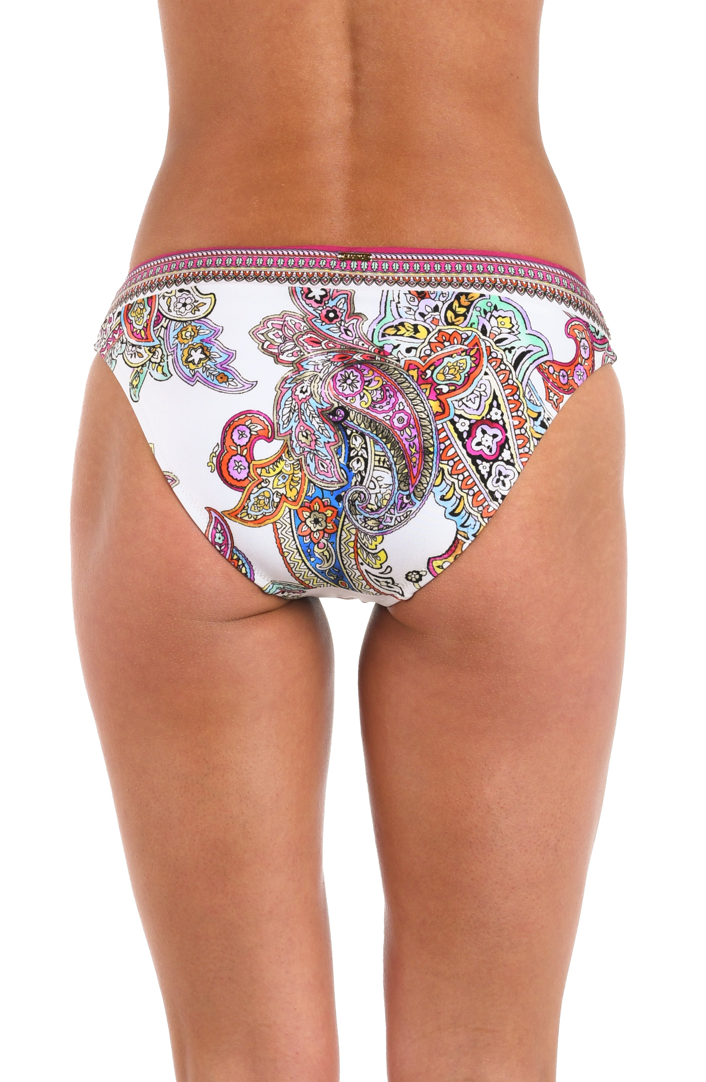 A woman wearing bikini bottoms with a white base, colorful paisley print, and a pink and multicolor patterned waistband.