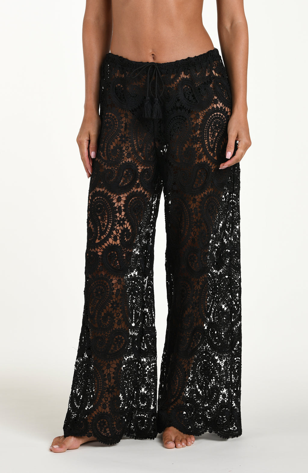 Black lace pants worn by a person on a white background