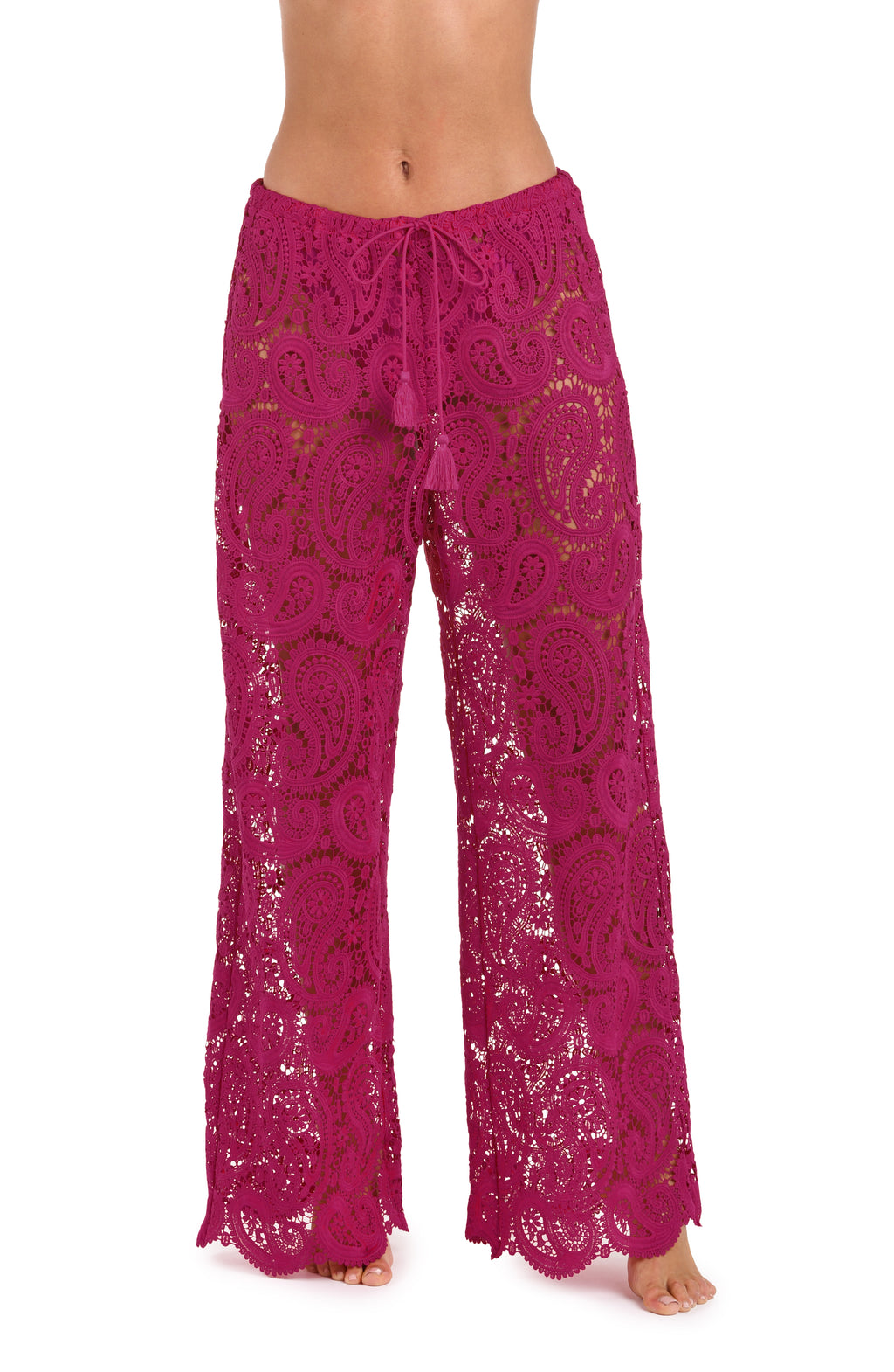 A person wearing bright fuchsia lace wide-leg pants with a drawstring waist against a white background.
