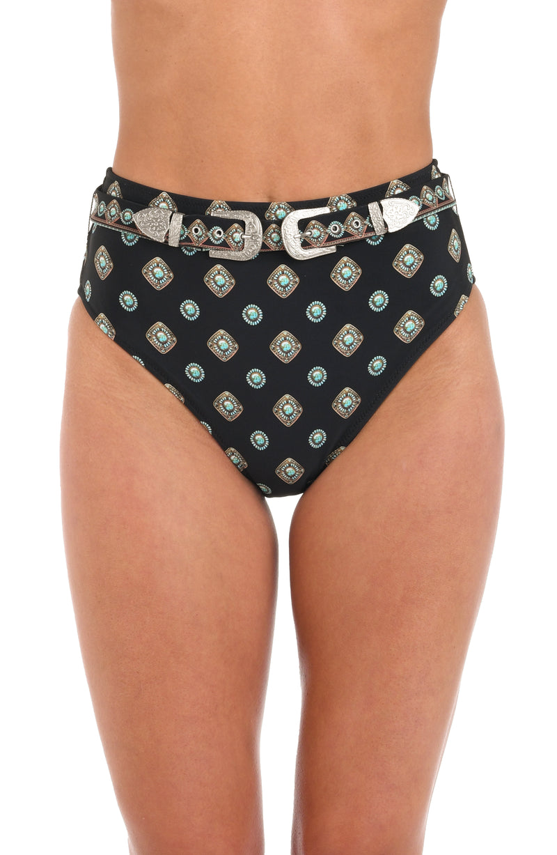 Woman wearing a black multicolored geometric printed high waist bikini bottoms set against a white background. 