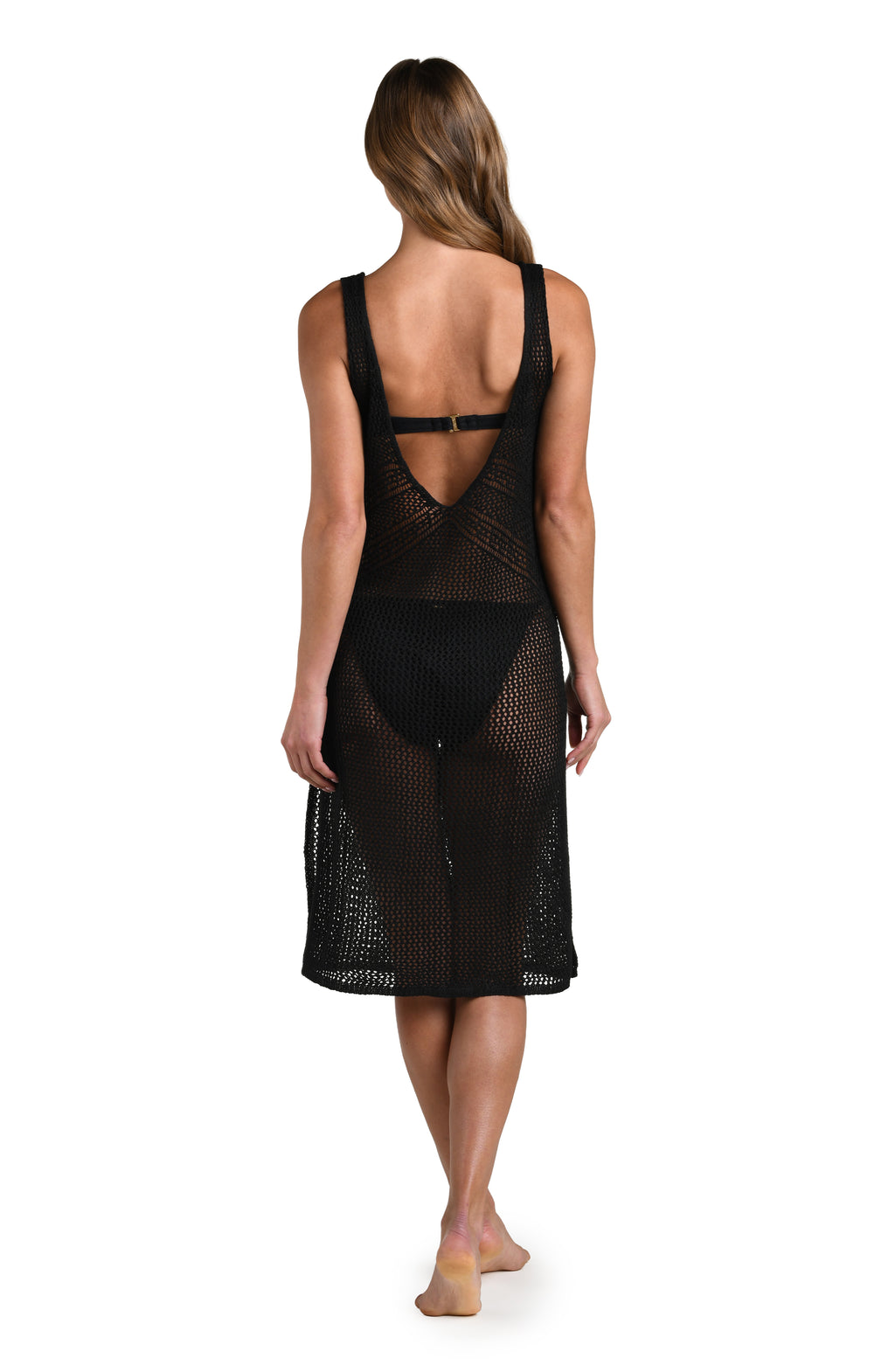Woman wearing a solid black midi dress cover up against white background. 