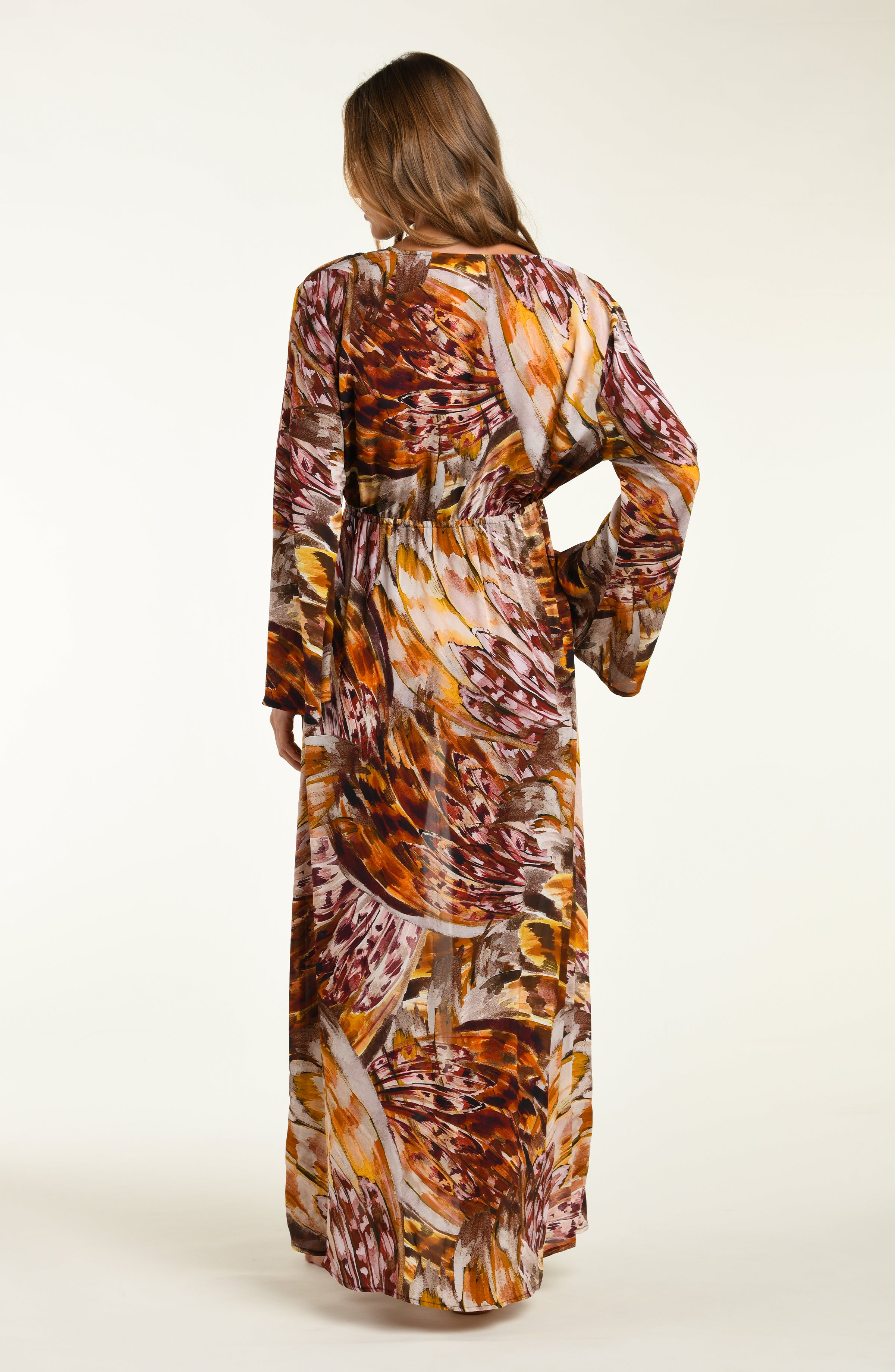 Woman wearing a long, patterned robe on a white background