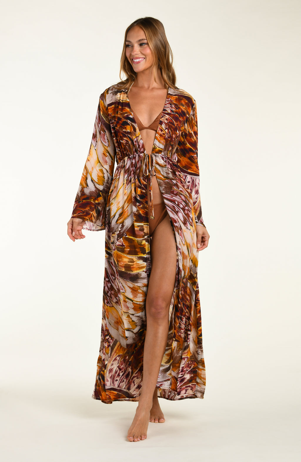 Woman wearing a long, patterned robe on a white background