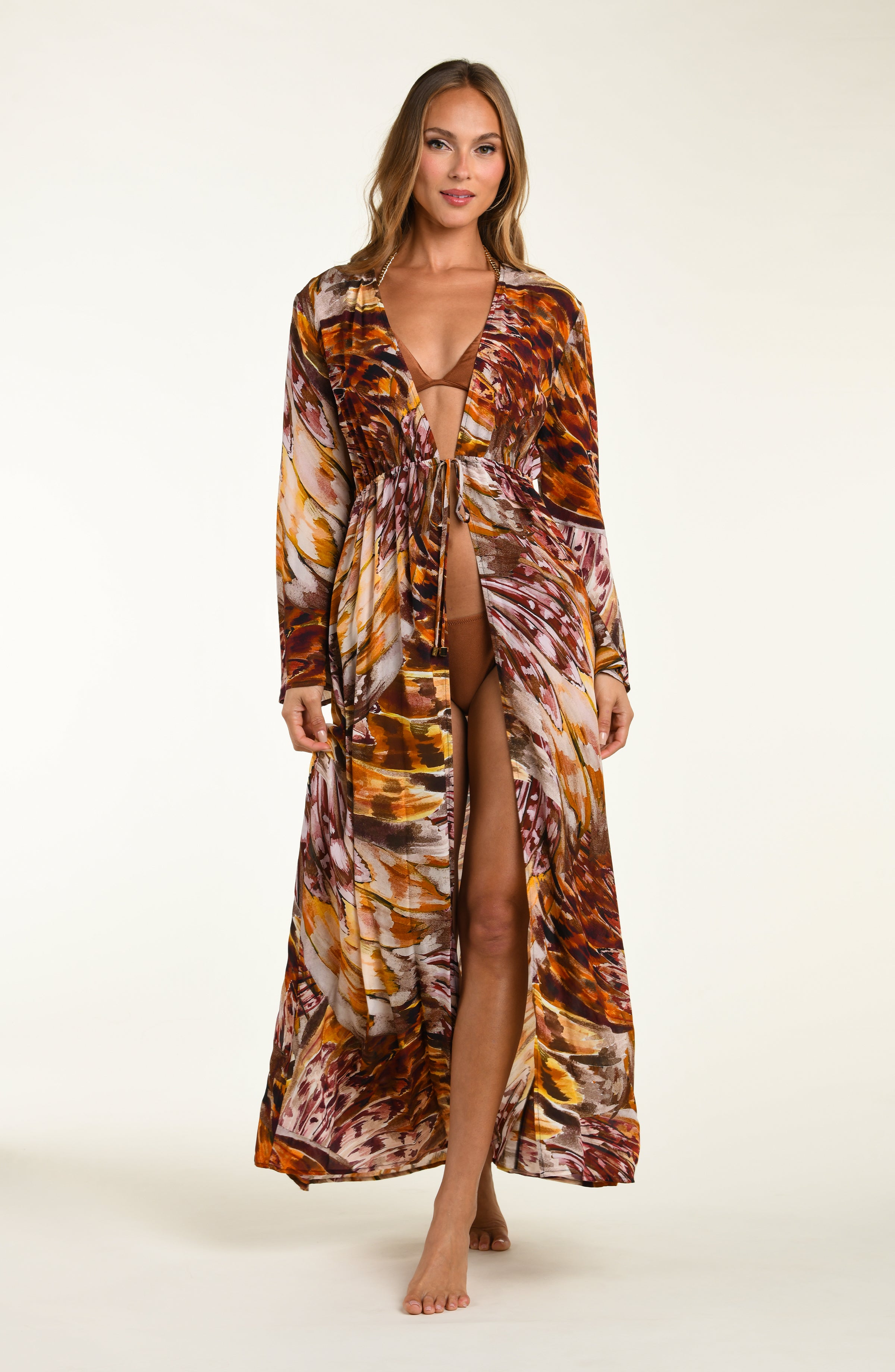 Woman wearing a long, patterned robe on a white background