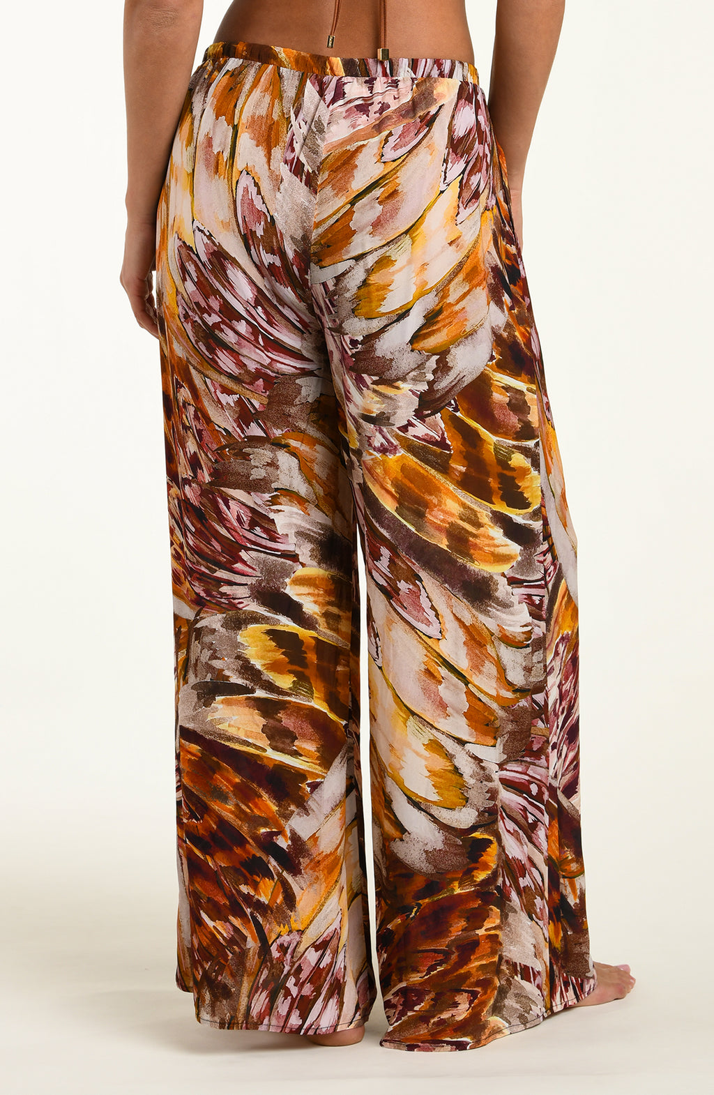 Woven pants with a multicolor pattern on a white background